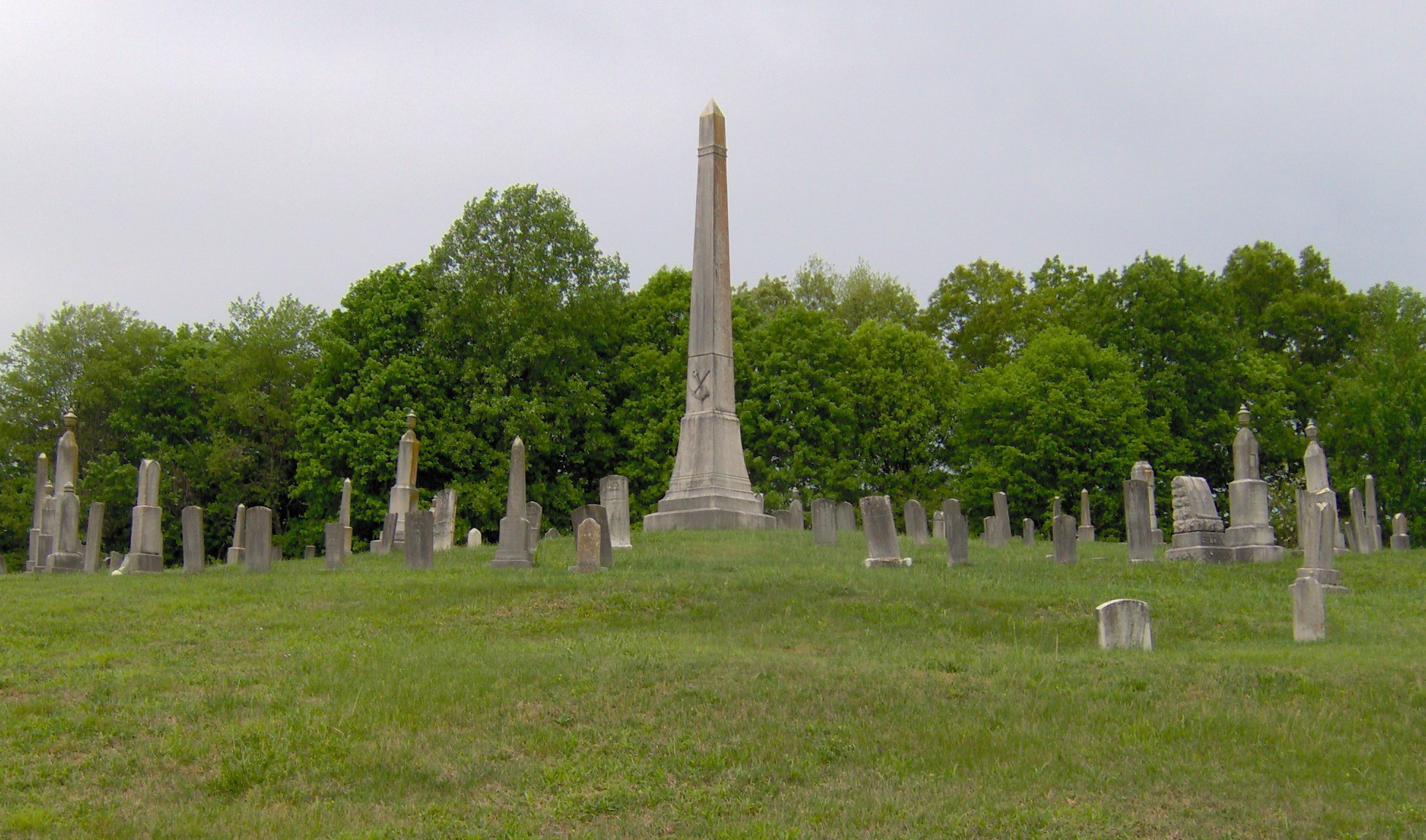 The Fraterville Miners' Circle at Leach Cemetery (behind Clear Branch Baptist Church) in Lake City, in the U.S. state of Tennessee.  The circle contains the graves of 89 miners killed in the Fraterville Mine Disaster, which occurred opposite Walden Ridge in the community of Fraterville, on May 19, 1902.  The explosion killed 216 miners, 184 of whom were identified.  The names of these 184 miners are listed on the obelisk at the center of the circle.  The circle was added to the U.S. National Register of Historic Places in 2005.