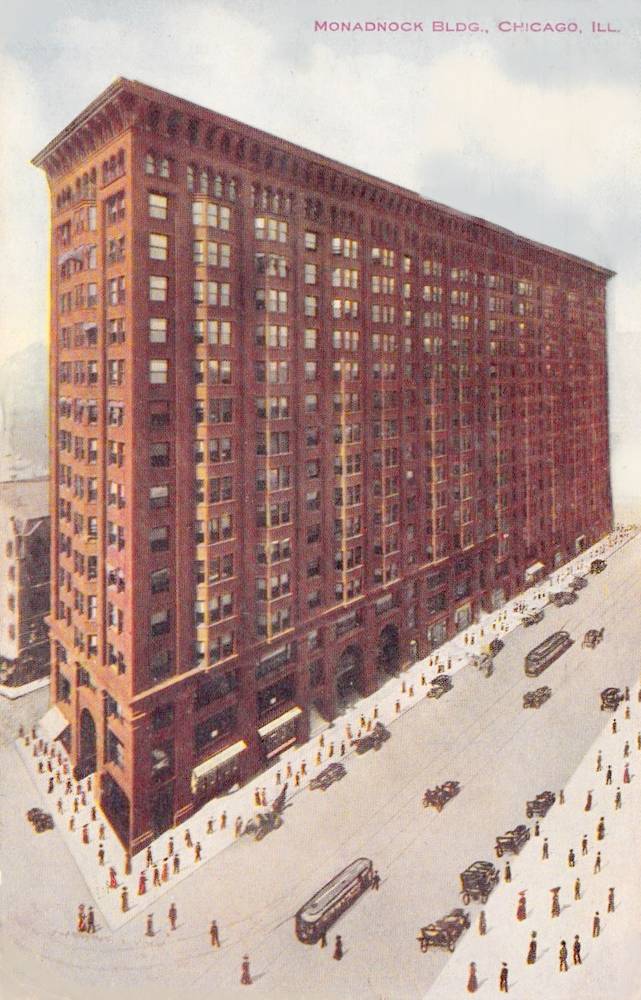 Vintage postcard captioned: "Monadnock Building, Dearborn, Jackson and Van Buren St., Chicago. The largest office building in Chicago." Aerial view facing northwest from corner of Dearborn and Van Buren.