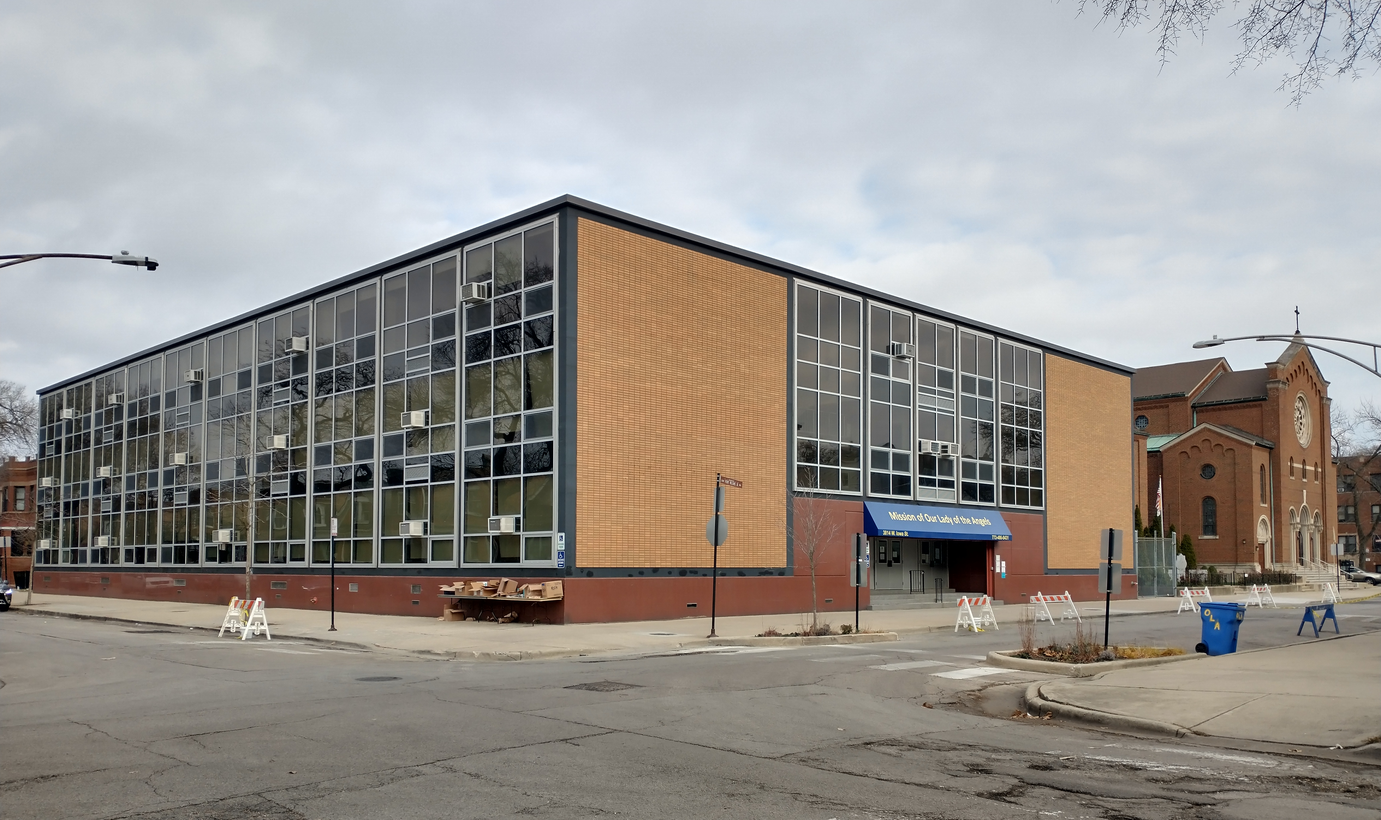 Negligence or arson?
December 1, 1958. In the basement of Our Lady of Angels Catholic grade school a fire began in a trash can at 2:00 in the afternoon. Thick smoke coming up the stairwell was noticed by three girls returning from an errand. They ran to the second floor to alert teachers.
Meanwhile a window near the fire shattered which allowed oxygen to flow in and fuel the fire. The blaze then quickly swept upstairs consuming five different rooms on the second floor of the north wing. 92 students and three nuns died. Many were injured leaping from windows 25 feet above the ground. Some students were burned so severely that, when firemen tried to pick them up, their bodies broke apart.
As a result of this fatal fire 68% of all American schools made fire safety improvements. Hollywood celebrities like Jack Benny came out to offer comfort to the children in hospital.
The cause of the fire has never been determined but the evidence points to arson. A 10-year old boy confessed to setting the fire. He confessed to several other arsons in the neighborhood and knew details of the Our Lady Of Angels fire that were not publicly known. But later he recanted the story and the matter was dropped.
The school was demolished and rebuilt in 1959.

Located at 909 N. Avers Ave.