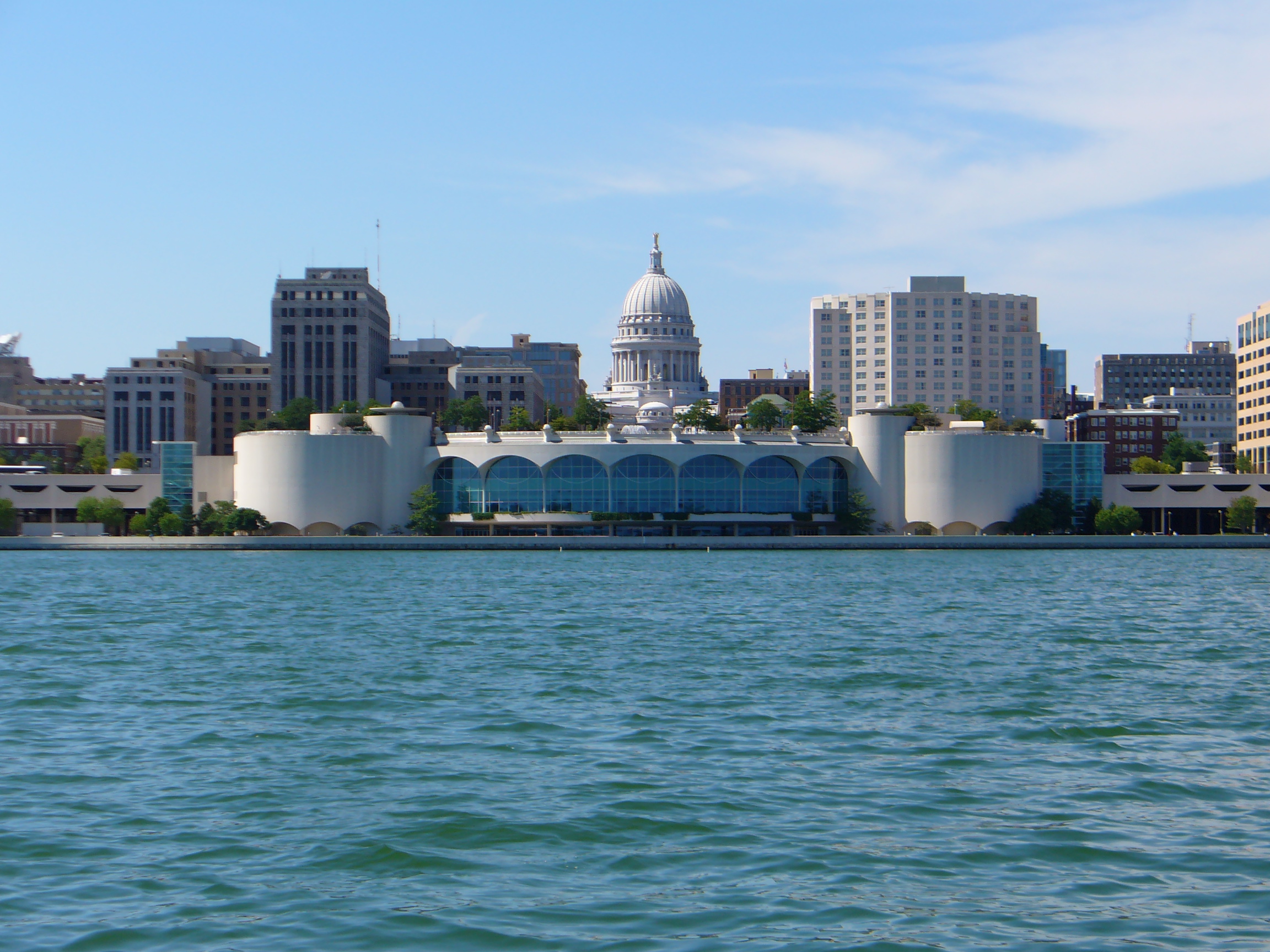 The skyline of Madison, Wisconsin as seen from Lake Monona. Monona Terrace is in the center of the picture with the capital directly behind it.