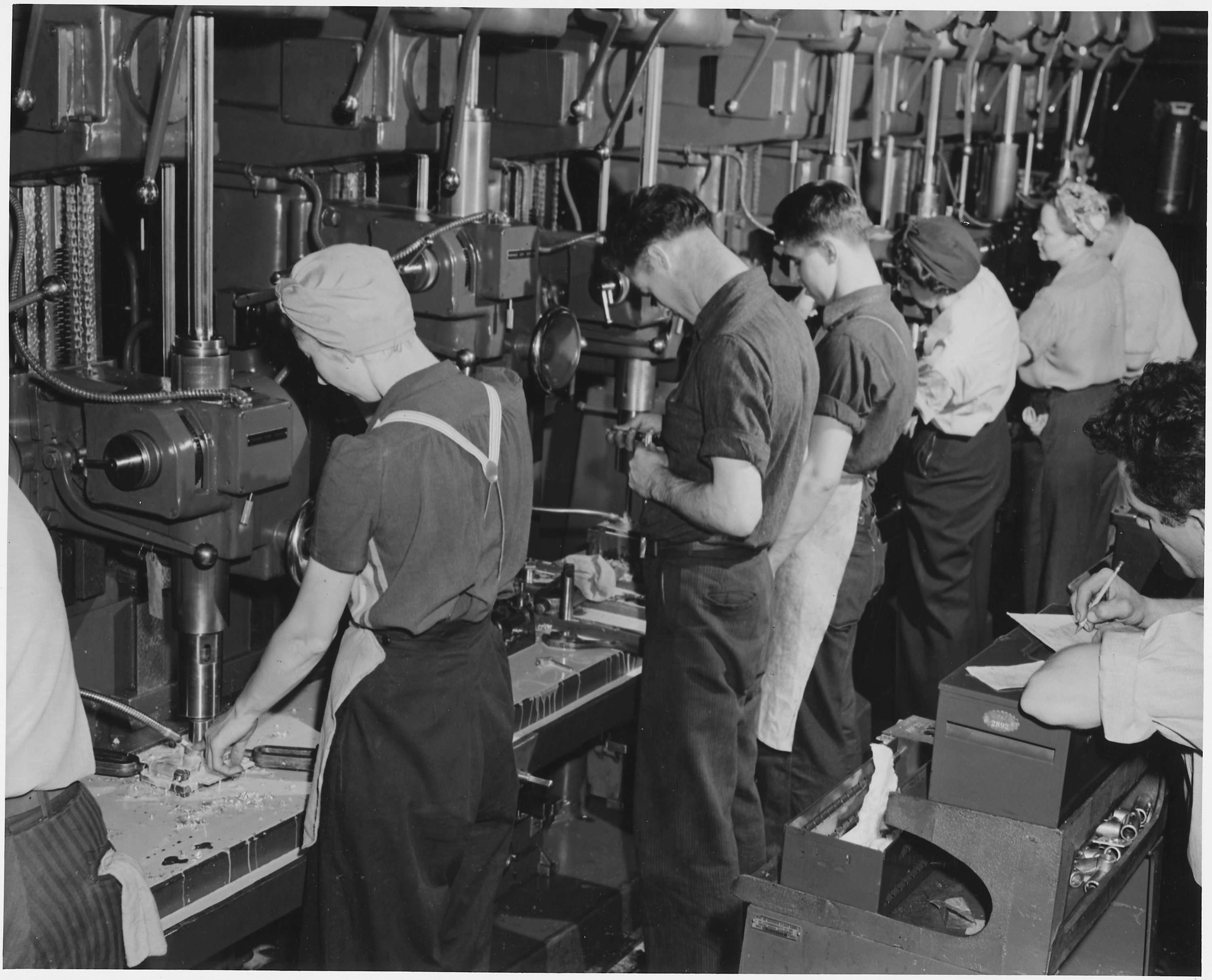 Both men and women man the machines which are turning out parts for America's bomber planes at Willow Run, Mich. - NARA - 195476.jpg
