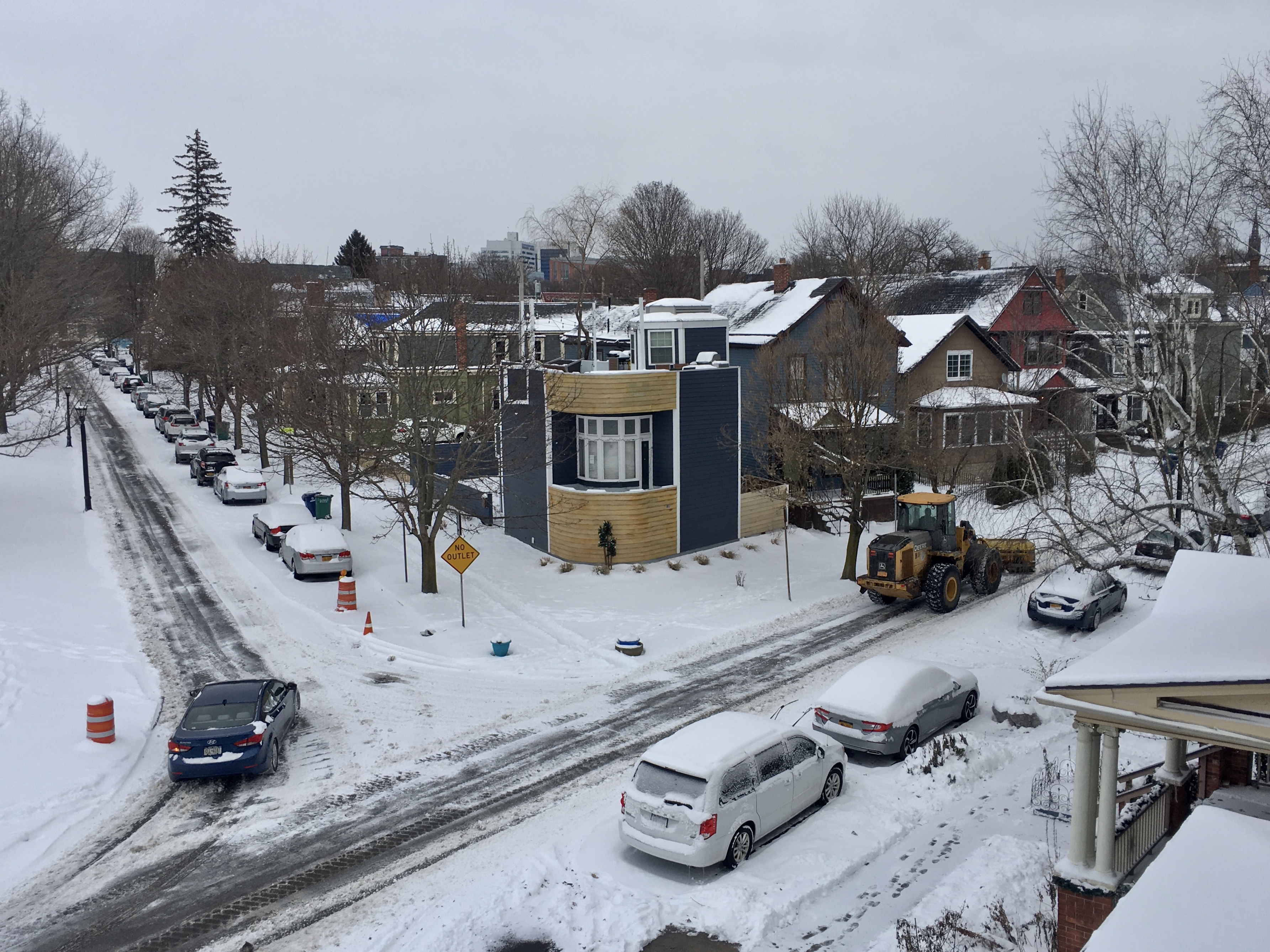 A front-end loader (right) clears snow off of Cottage Street after a blast of lake-effect snow in Buffalo, New York in the morning and afternoon of December 11, 2019.