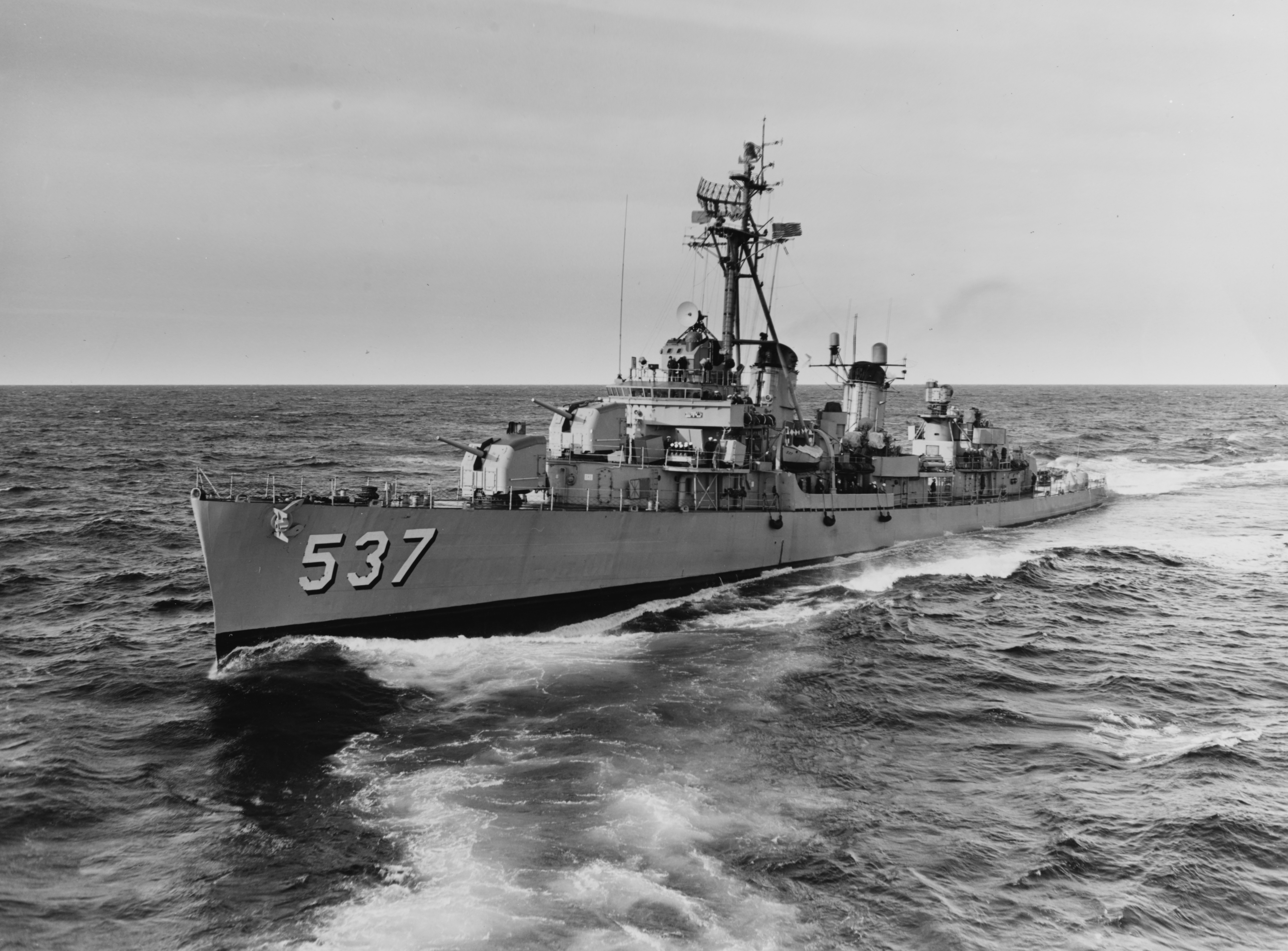 The U.S. Navy destroyer USS The Sullivans (DD-537) passing astern of the destroyer tender USS Grand Canyon (AD-28) off Newport, Rhode Island (USA), on 29 October 1962. The Sullivans was assigned to the blockading forces during the Cuban Missile Crisis.