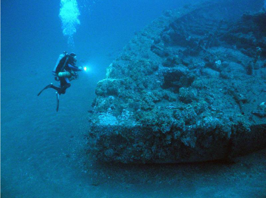 A diver examines the wreck of USS Monitor.