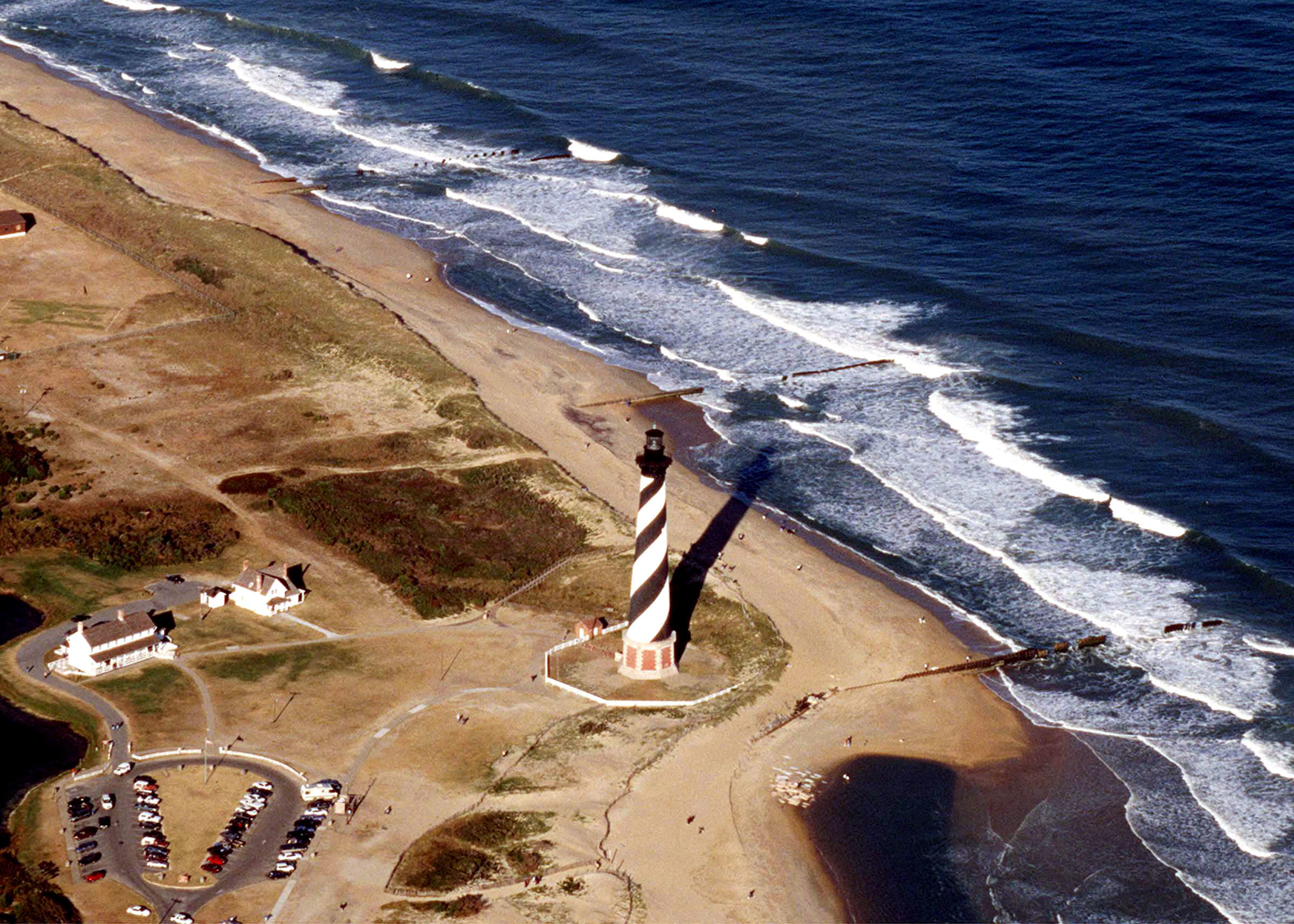A U.S. Air Force C-130E Hercules flies over the Cape Hatteras Lighthouse on the North Carolina coast on Jan. 1, 1999. The Hercules is the Air Force's main transport for intratheater airlift. Capable of operating from rough, dirt, landing strips, the aircraft is the prime transport for dropping paratroops and equipment into hostile or remote areas. This Hercules is attached to the 2nd Airlift Squadron, Pope Air Force Base, N.C.