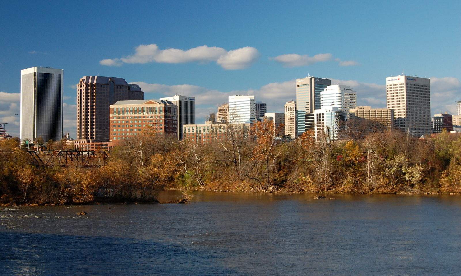 Skyline of Richmond, Virginia with the James River in the foreground. The building to the far left is the Federal Reserve.