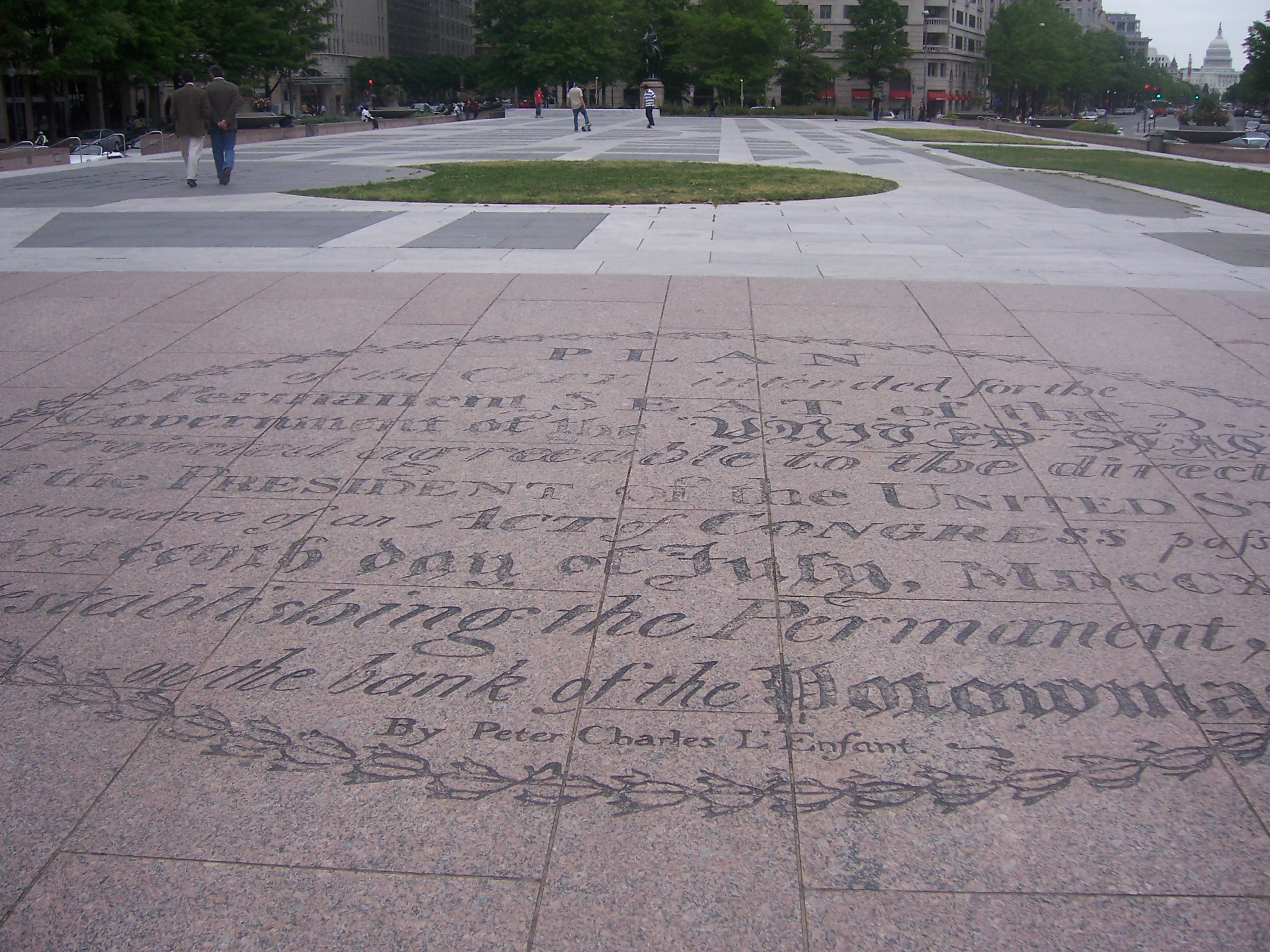 Text in oval near the west end of Freedom Plaza. The oval contains the title legend of L'Enfant's original plan for the City of Washington.  The title legend identifies the plan's author as "Peter Charles L'Enfant".