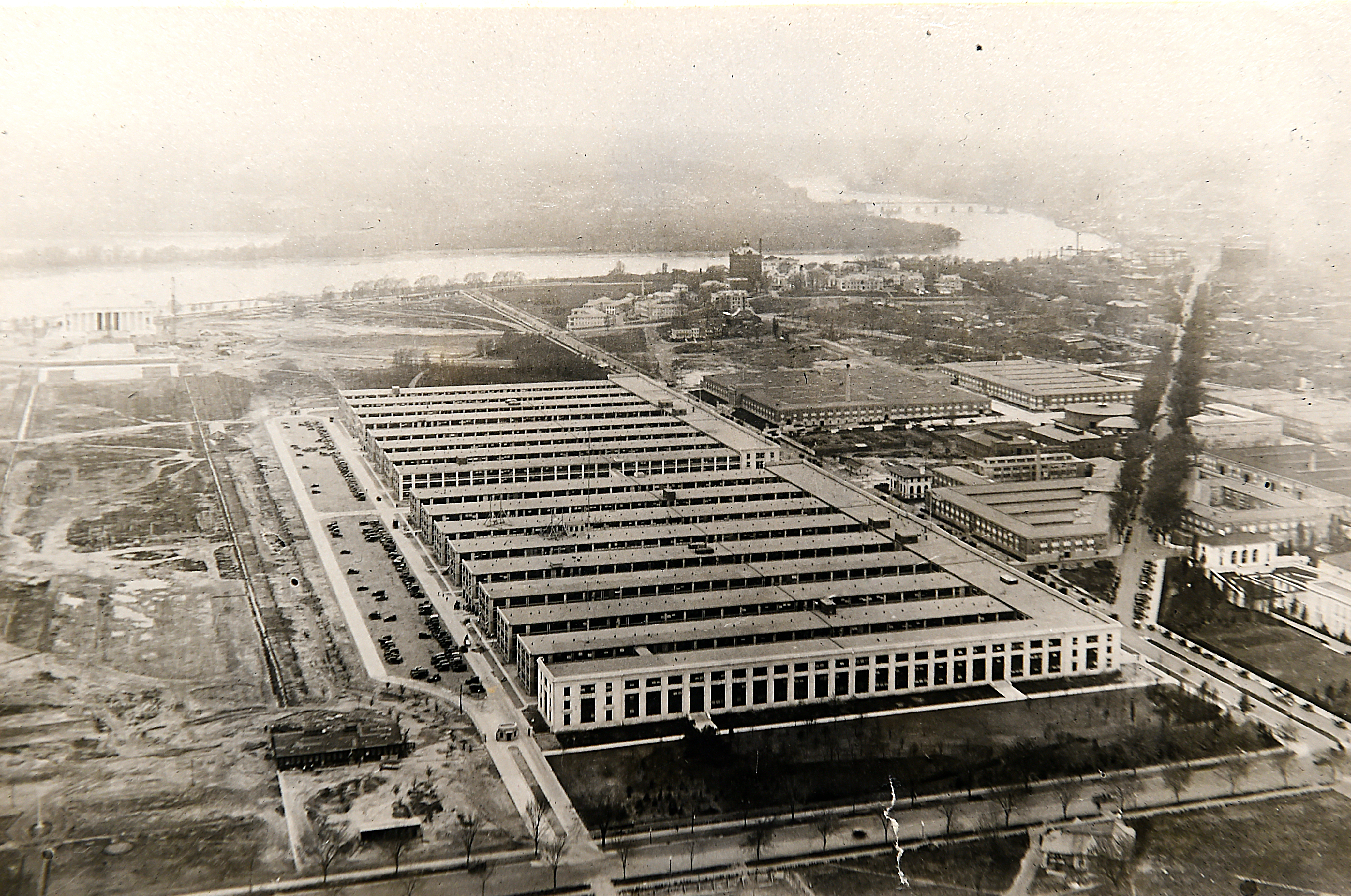 Main Navy and Munitions Buildings. Photographed from the top of the Washington Monument, circa 1918, looking about west with the Potomac River in the distance. Main Navy is the nearer of the two structures, with nine wings as first completed. The Munitions building had only eight wings. Constitution Avenue, NW, runs along the structures' northern face and 17th Street is in the foreground. Note the many World War I temporary buildings in the area to the north of Constitution Avenue. The Lincoln Memorial is in the left distance, with the Reflecting Pool under construction in front of it. The Naval Hospital is in the right center background, on the near side of the river.
The buildings were temporary structures built during World War I on the National Mall in Washington, D.C.  The buildings remained in use for several decades, and the Secretary of War was headquartered in the Munitions Building from 1936 until the Pentagon opened in 1943.