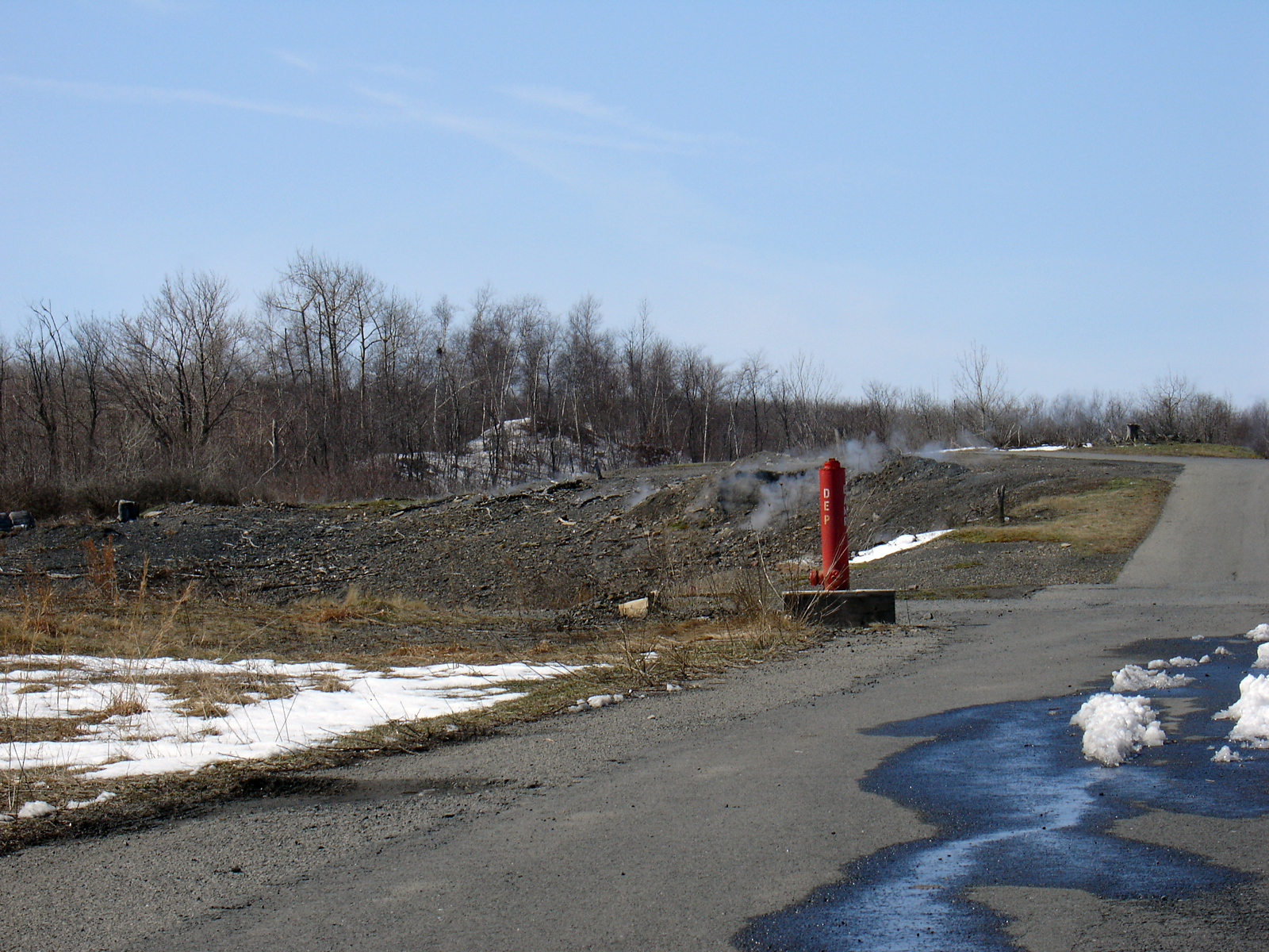 View of the outcrop area of the Buck Mountain coal seam in Centralia, Pennsylvania, where the underground coal mine fire has burned close to the surface. The municipal dump in which the fire started is on this same outcropping, but about a third of a mile east of this location behind the Odd Fellows Cemetery. It should be noted that areas which were not affected by the mine fire had 4-6 inches of snow on the ground.
