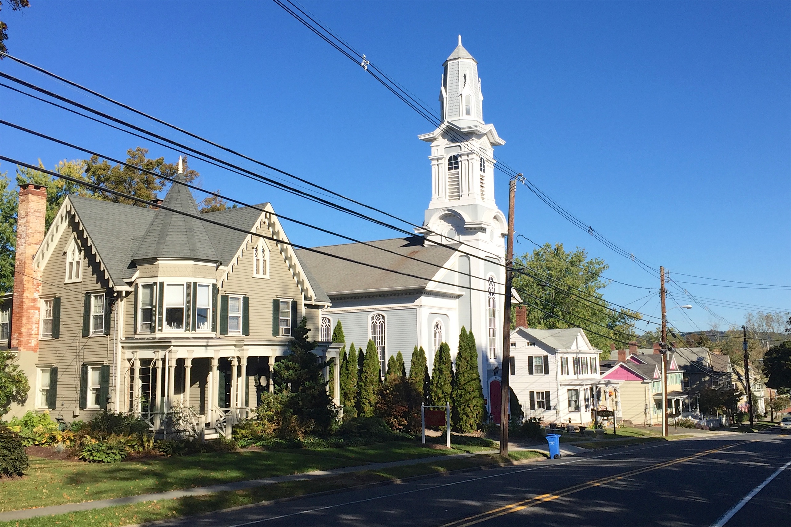 View of Main Street, looking north, in Oldwick, New Jersey. Pivotal contributing properties of the Oldwick Historic District, the Charles E. Dickerson House and the Oldwick Methodist Church, are featured on the left in the foreground.