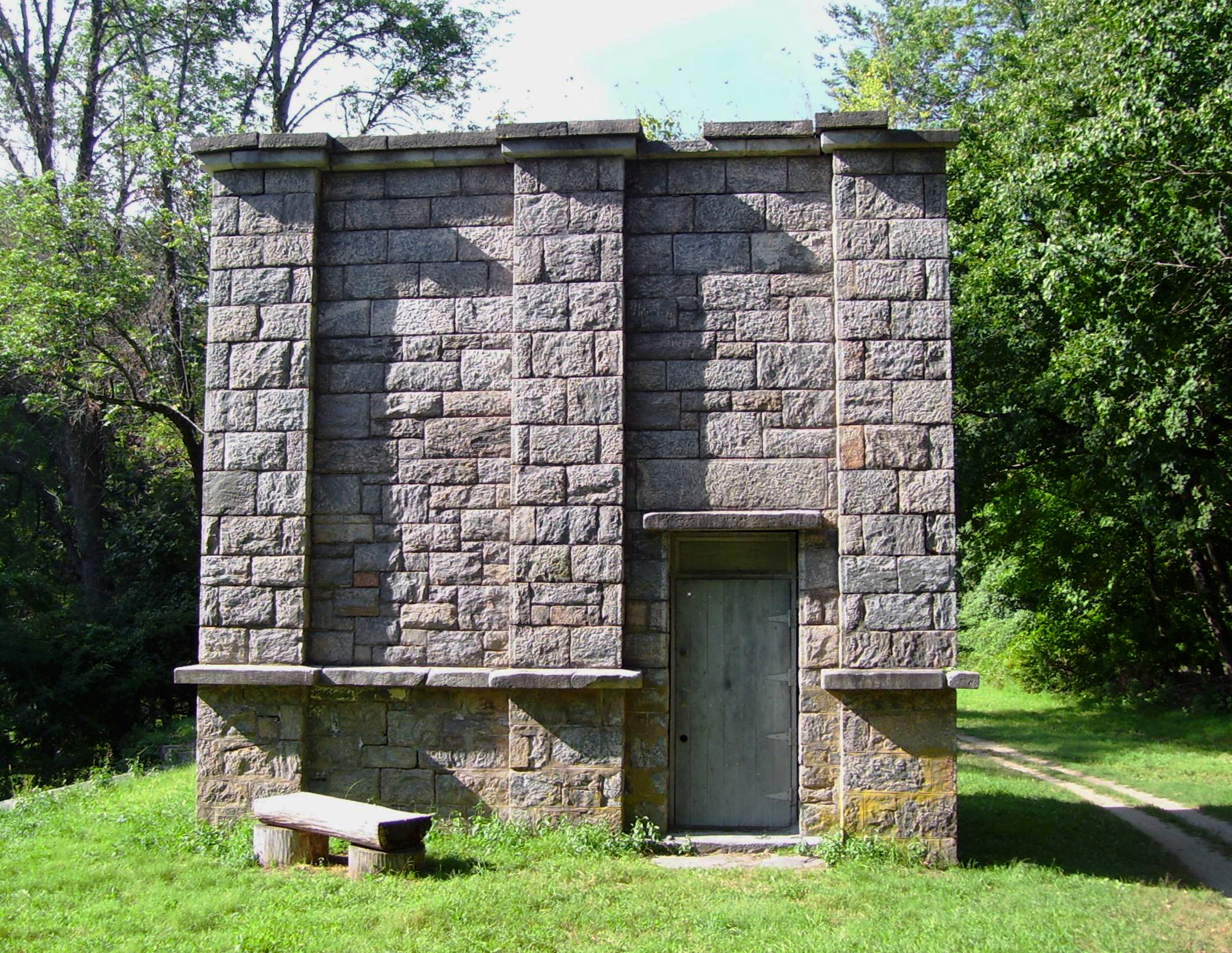 A weir chamber of the Croton Aqueduct in Sleepy Hollow, New York. These chambers – another is located in Ossining, New York – were used to empty the aqueduct for maintanece by diverting the water to a nearby waterway, in this case the Pocantico River.  The line could be emptied in as little as two hours, according to a descriptive display at the Ossining chamber. The aqueduct is no longer in use for water delivery, and the right-of-way is now a New York State Historic Park used for walking, jogging and bicycling.