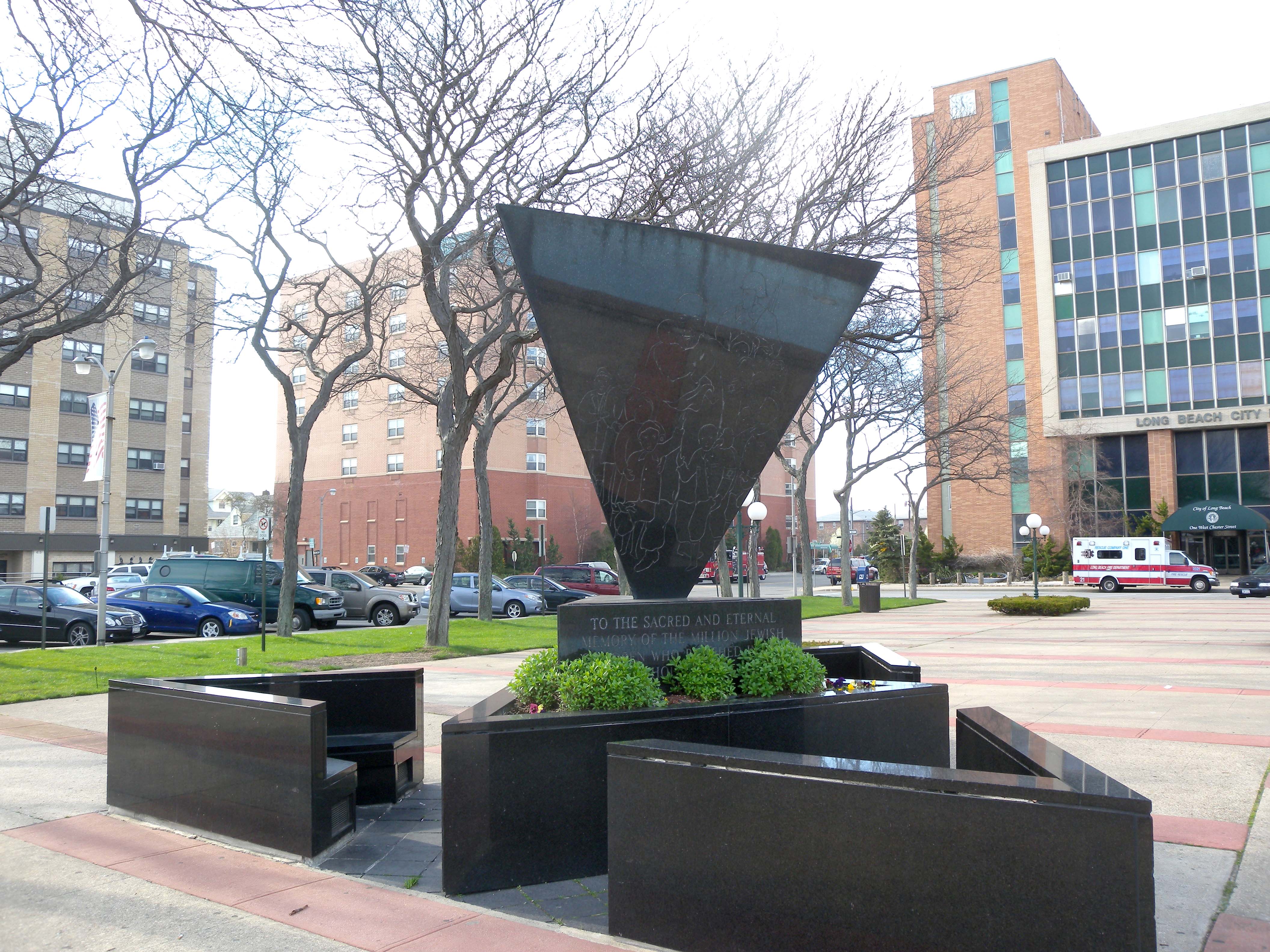 Looking northwest at Holocaust memorial in front of Long Beach City Hall on a partly sunny afternoon.