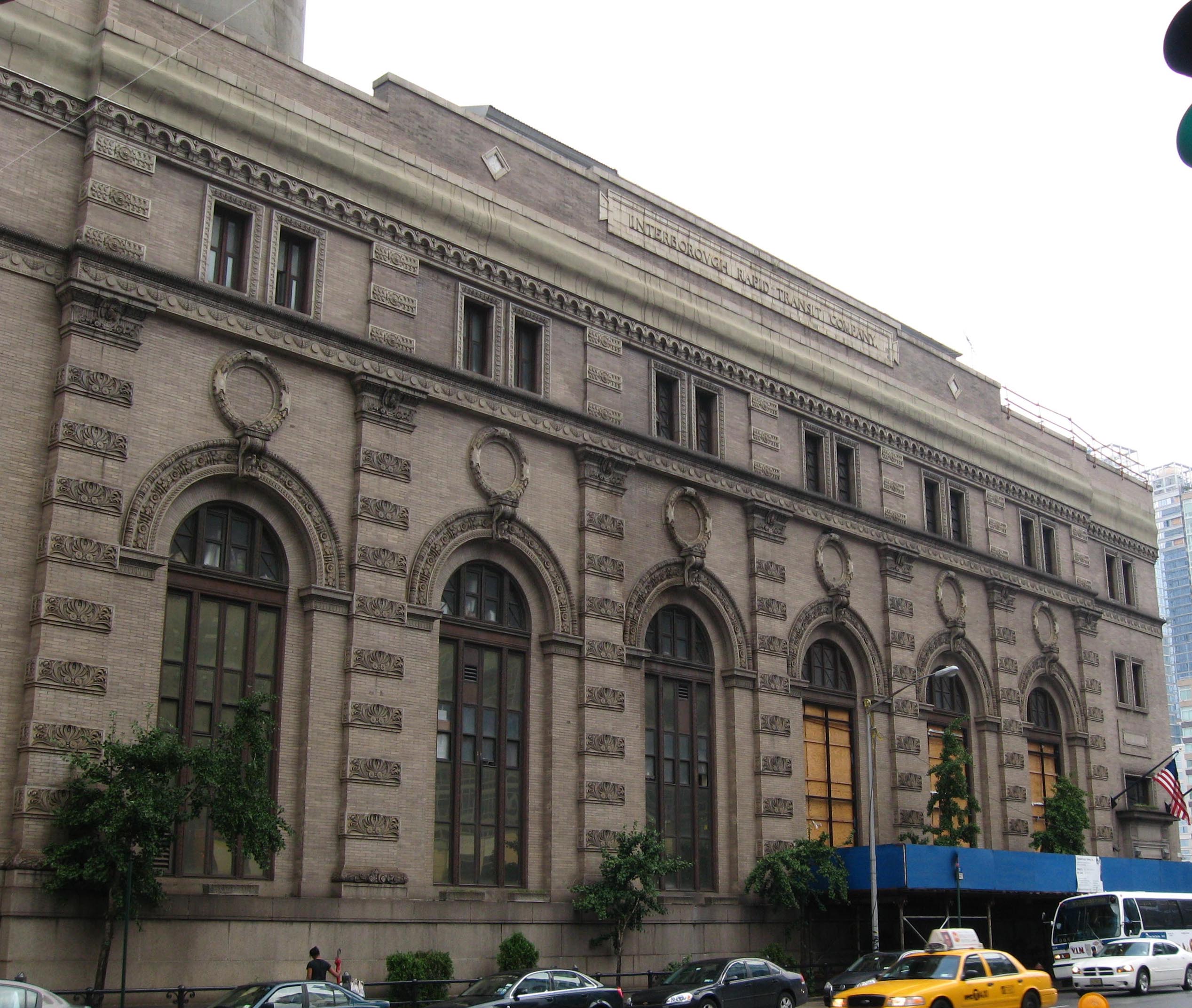 Looking up and north from 58th at former en:Interborough Rapid Transit Company power station at 11th Avenue and West 59th Street, Manhattan on a rainy late afternoon.  Owned and operated by Con Edison since the middle 20th century.  See also File:IRT 58 St power sunny jeh.jpg.