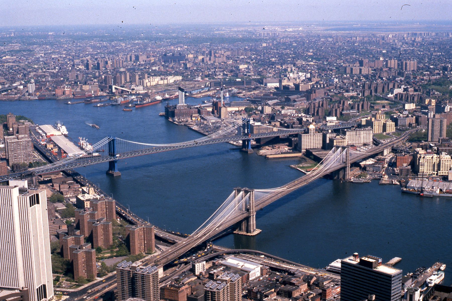 Manhattan and Brooklyn bridges on the East River, New York City, with Queens and Manhattan at top and bottom, 1981. For Bridges and tunnels in New York City.
Other information

Photo by George Garrigues.