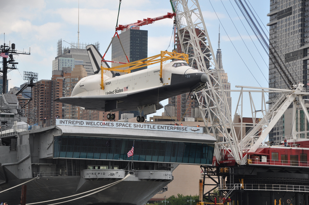 NEW YORK -- Space Shuttle Enterprise is lifted by crane onto the deck of the U.S.S. Intrepid June 6, 2012 after a trip up the Hudson River. The Enterprise will be permanently displayed at the USS Intrepid Air and Space Museum.  (U.S. Army Corps of Engineers photo by Dan Desmet)