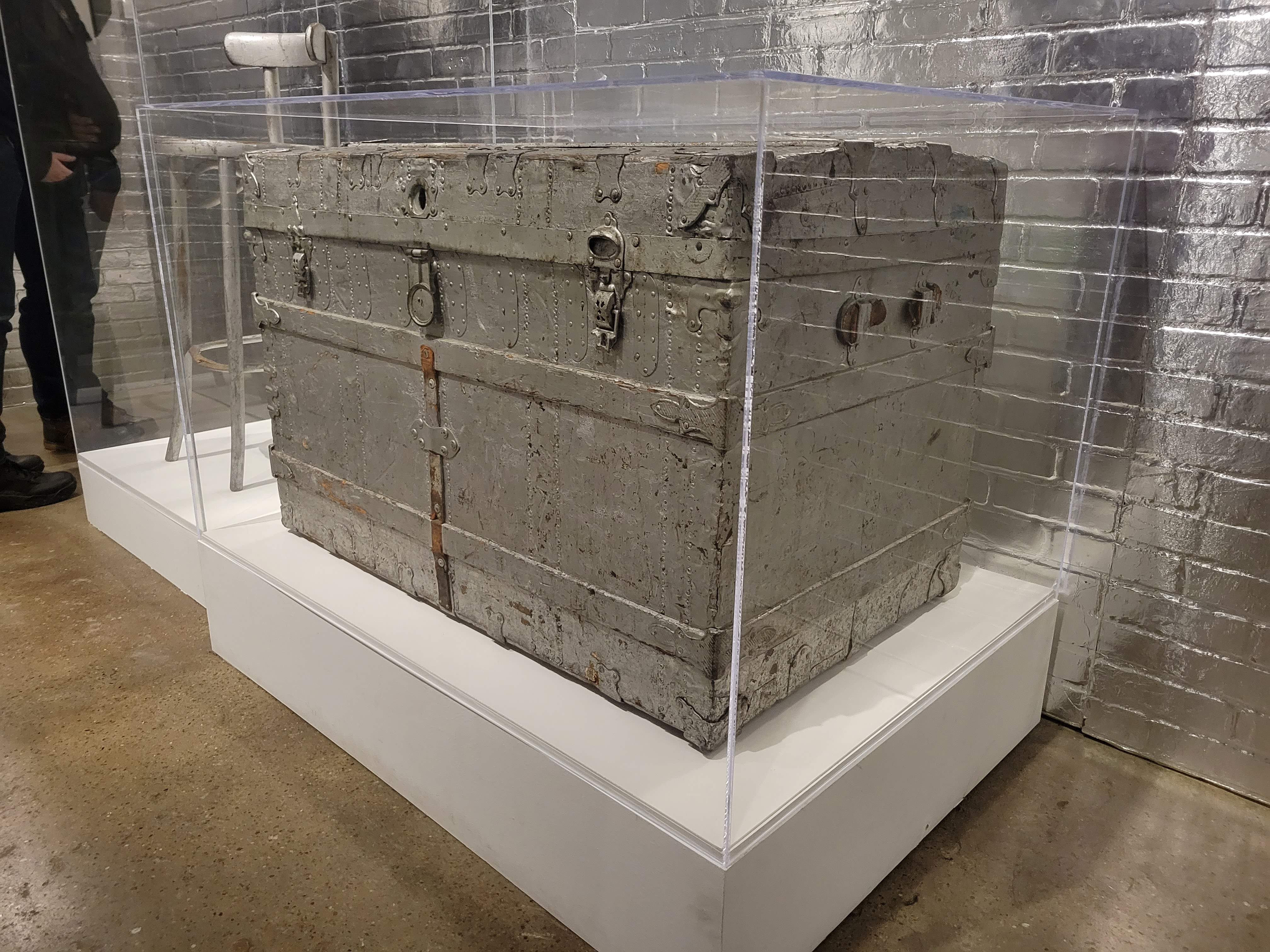 Oblique view of a silver painted trunk, owned by Andy Warhol, on display at the Warhol Museum in Pittsburgh, Pennsylvania. This trunk was used in Warhol's Silver Factory as a storage unit and film prop. Edie Sedgwick sits on this trunk in Warhol's film Vinyl. After Warhol's death in 1987 inside the trunk were found photographs, and photographic negatives by Billy Name, as well at the script of "Up Your Ass" by Valerie Solanas, which Warhol repeatedly told Solanas he had lost. This was one of the compounding reasons Solanas shot Warhol in 1968.