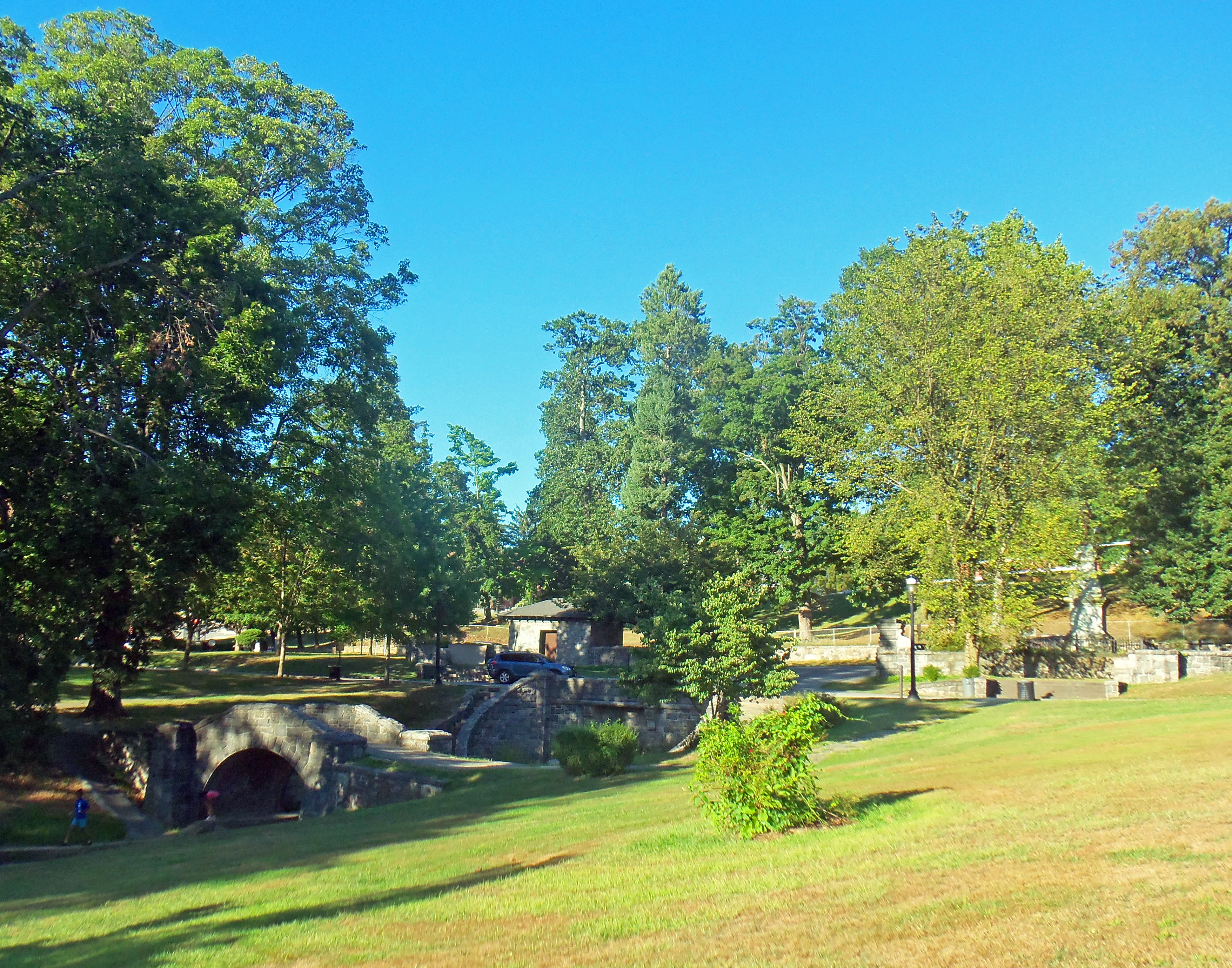 View of two bridges along brook and Captors' Monument in Patriot's Park, on the border between Tarrytown and Sleepy Hollow, NY, USA