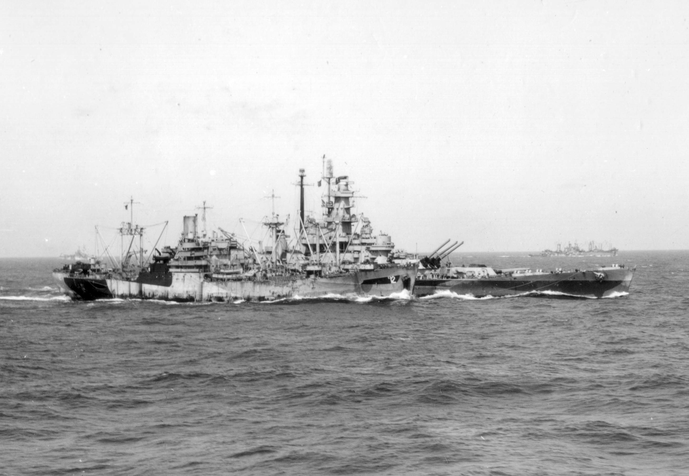The U.S. Navy battleship USS Massachusetts (BB-59) replenishing from the ammunition ship USS Wrangell (AE-12). Wrangell then retired to San Pedro Bay, Leyte, for upkeep and repairs. Wrangell subsequently returned to the open sea on 8 July 1945 and rendezvoused with TG 30.8 (the redesignated TG 50.8) on the 17th. From 20 July to 1 August 1945, she rearmed 35 ships and hit a high point of transferring 700 tons of ammunition in a single day.