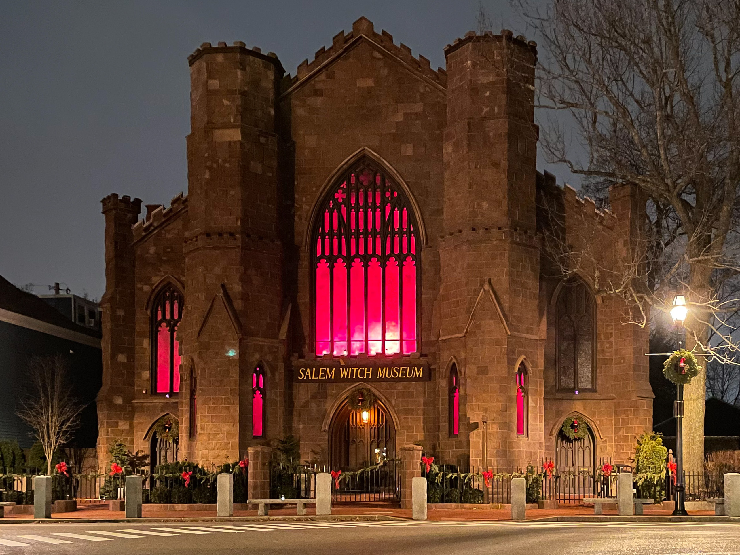 The Witch Museum in Salem, Massachusetts, shortly after dusk, in January 2021. It is still adorned with its holiday decorations.
