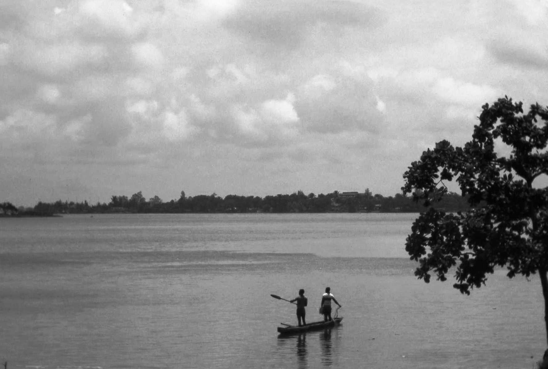 Ébrié Lagoon, with boaters, in Abidjan, Côte d'Ivoire.