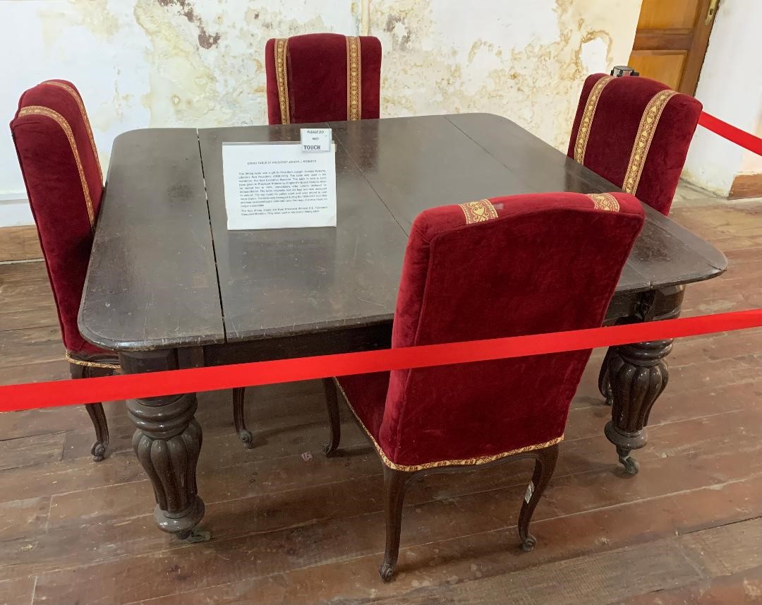 A gift from England's Queen Victoria to visiting Liberian President Joseph Jenkins Roberts in 1848, this dining table was used in his residence, the first Executive Mansion.  The chairs are from  President William V. S. Tubman's Executive Mansion where they were part of his formal dining table.
