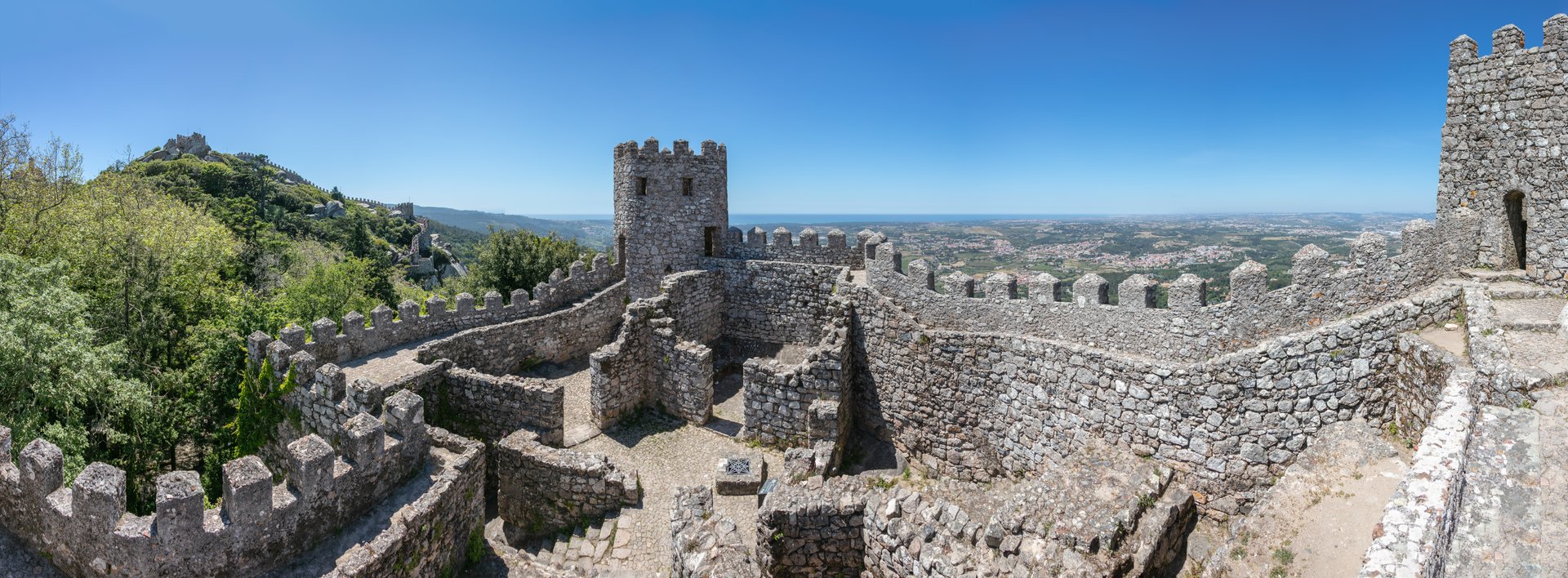 Panoramic view of the interior of the castle of the Moors, a hilltop medieval castle located in the municipality of Sintra, about 25 kilometres (16 mi) northwest of Lisbon. Built by the Moors in the 8th and 9th centuries,  the UNESCO World Heritage Site was an important strategic point during the Reconquista, and was taken by Christian forces after the fall of Lisbon in 1147.