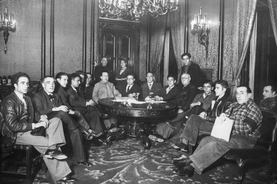 Junta de Defensa de Madrid. Sitting: Luis Nieto de la Fuente (3rd from left), Jose Cazorla Maure (7th from left), Santiago Jose Carrillo Solares (8th rd from left), Enrique Jimenez Gonzalez (9th rd from left), Fernando Frade (10th rd from left), gen. Jose Miaja Menant (11th rd from left) Maximo de Dios (12th rd from left), Mariano Garcia Cascales (13th rd from left)
