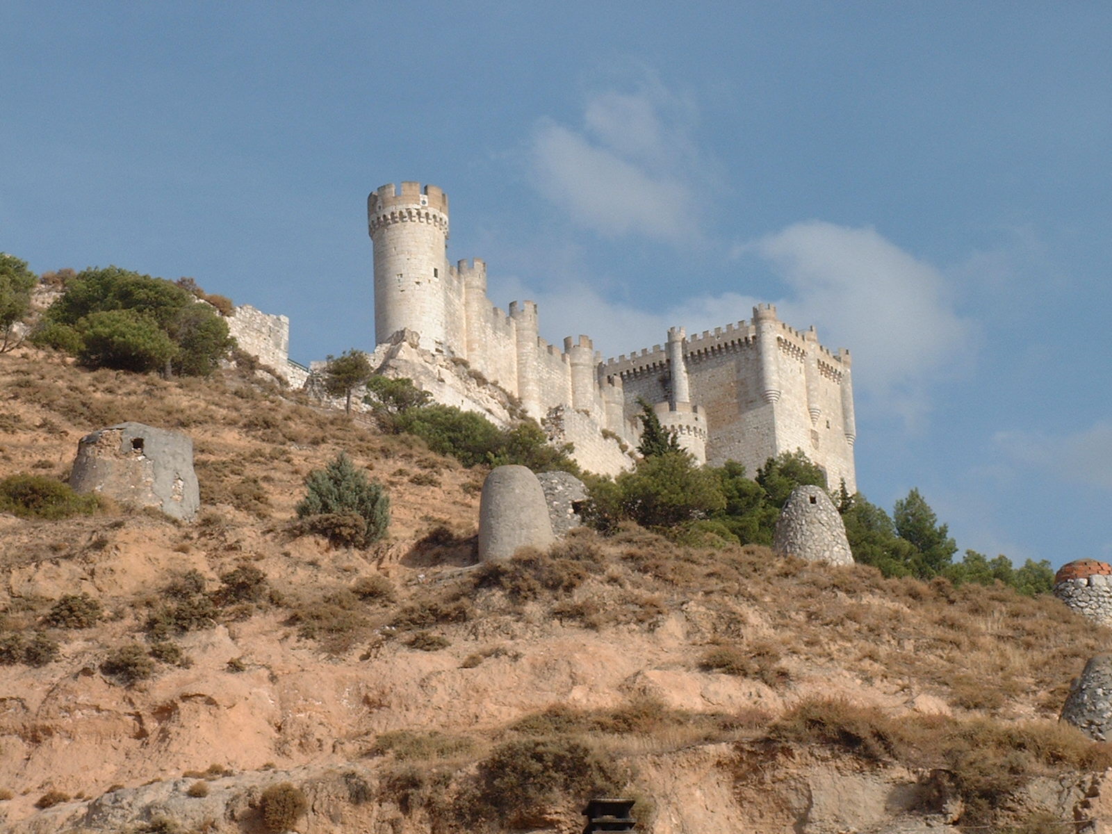 Castillo de Peñafiel, Peñafiel Castle, Valladolid, Spain. Viewed from NW. The vents in the foreground are for the ventilation of underground caves used as wine cellars because they keep constant low temperature all around the year.