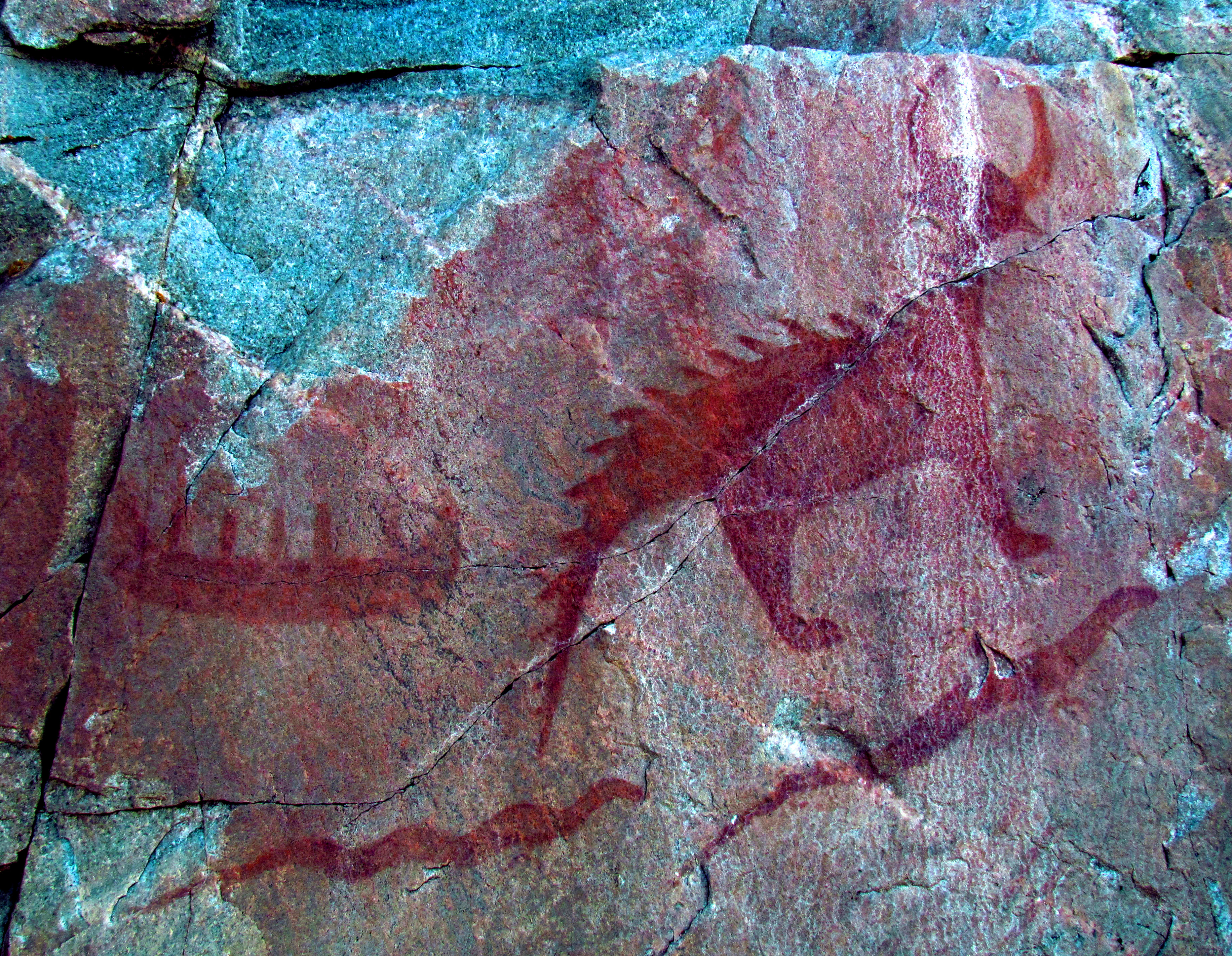 Canoe (top left), Michipeshu (top right), and two giant serpents (chignebikoogs), panel VIII, Agawa Rock, Lake Superior Provincial Park, Ontario, Canada