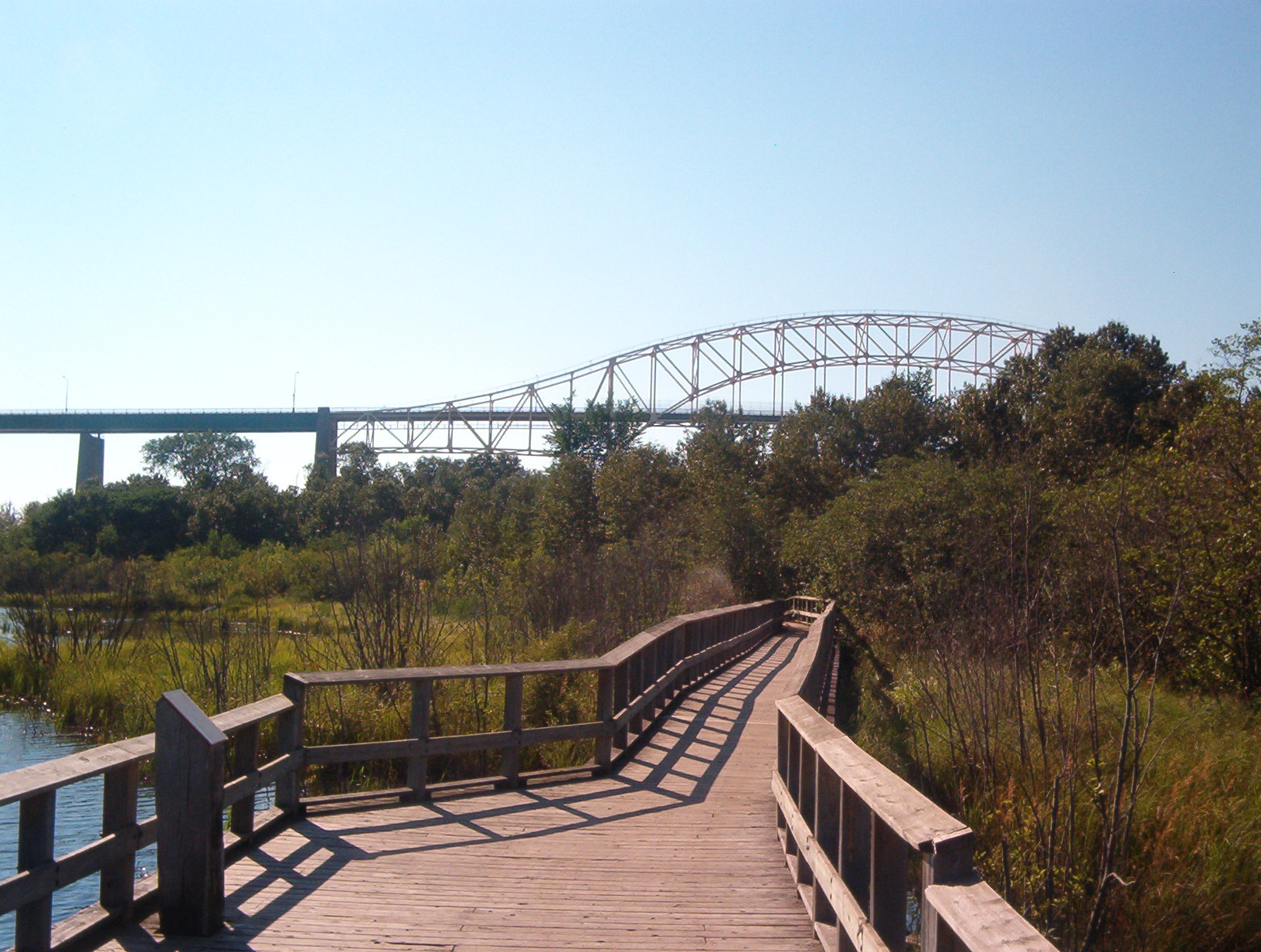 Boardwalk along the Attikamek Trail with the Sault Ste. Marie International Bridge in background, Sault Ste. Marie Canal National Historic Site of Canada.