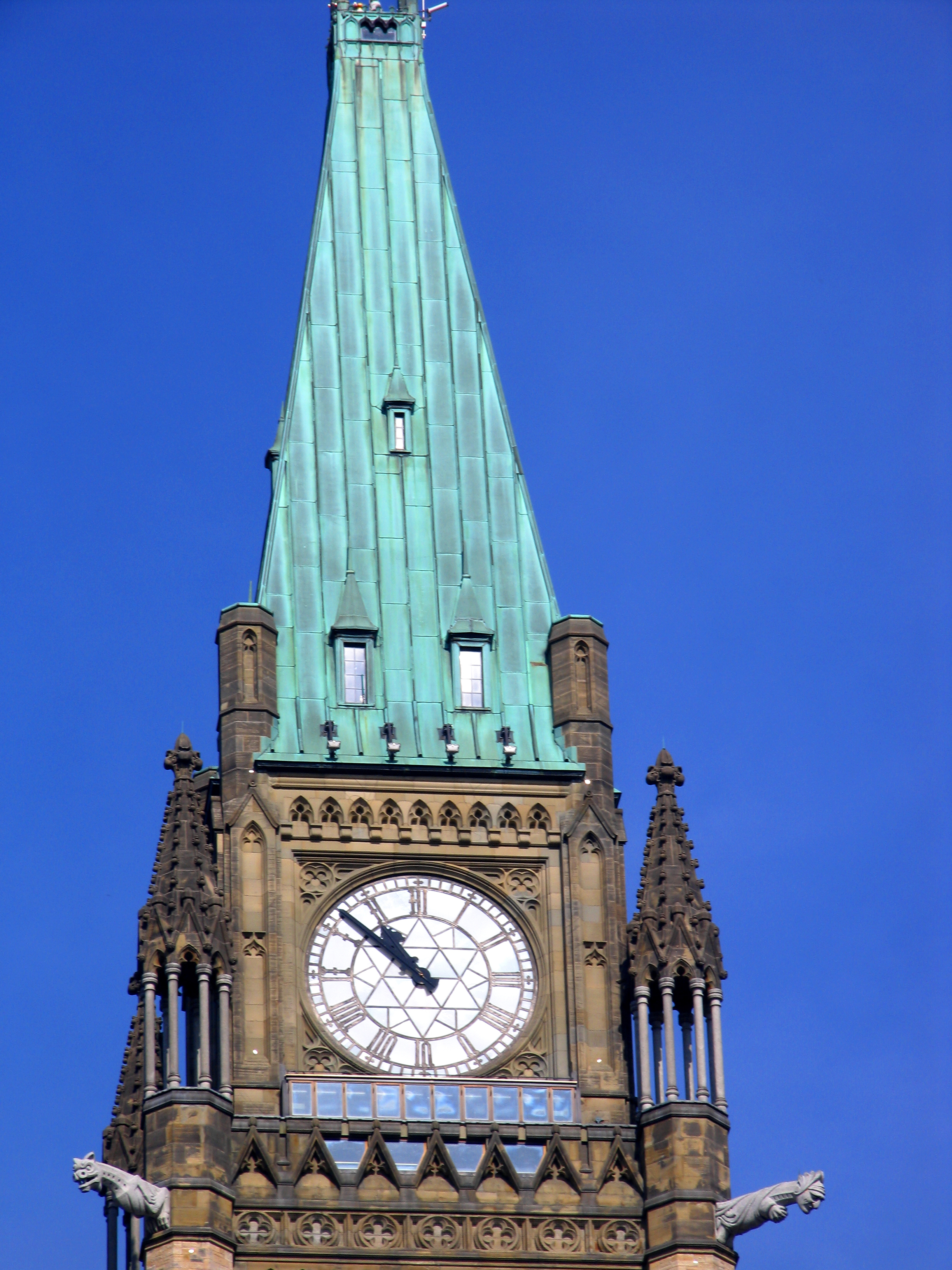 Peace Tower, Parliament buildings, Ottawa, Canada. Note the observation deck windows below the clock. The Roman numeral for 4 o'clock (IIII) is not in modern subtractive notation : IV, strange quirk which only applies to clocks according to WikiPedia.
