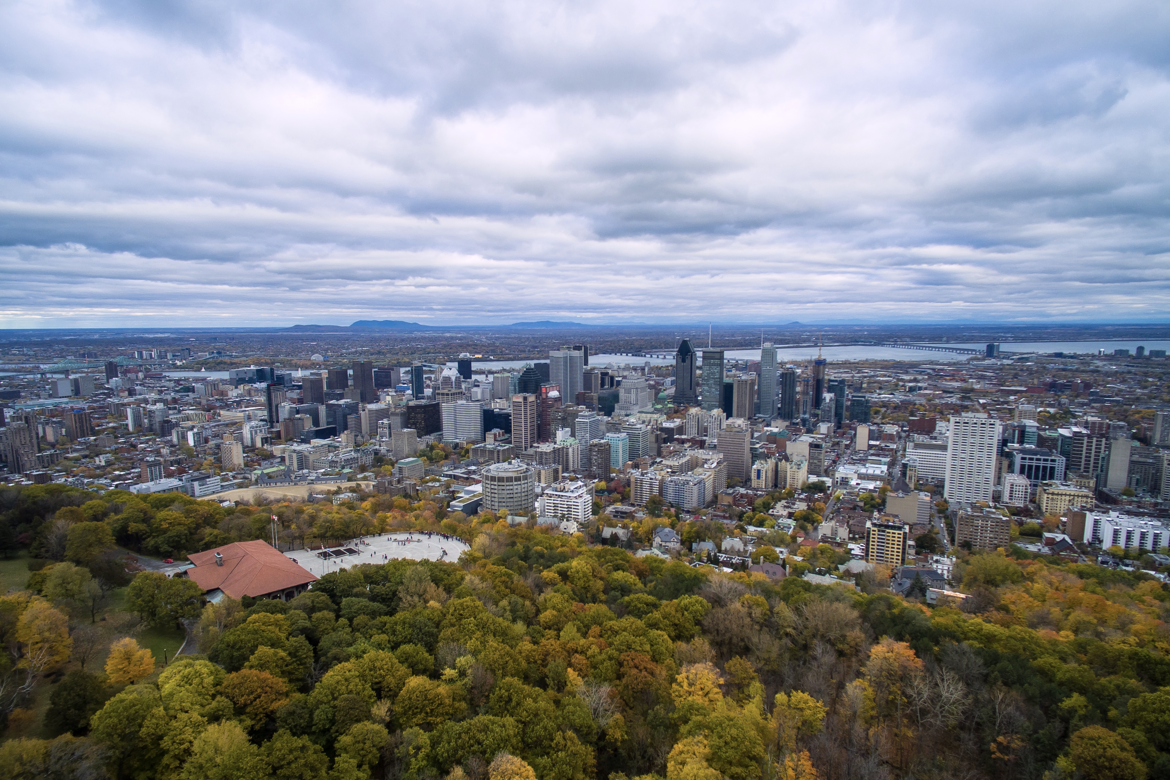 Aerial photo of downtown Montreal taken from above Mount Royal. The Kondiaronk Belvedere can be seen near the bottom left.