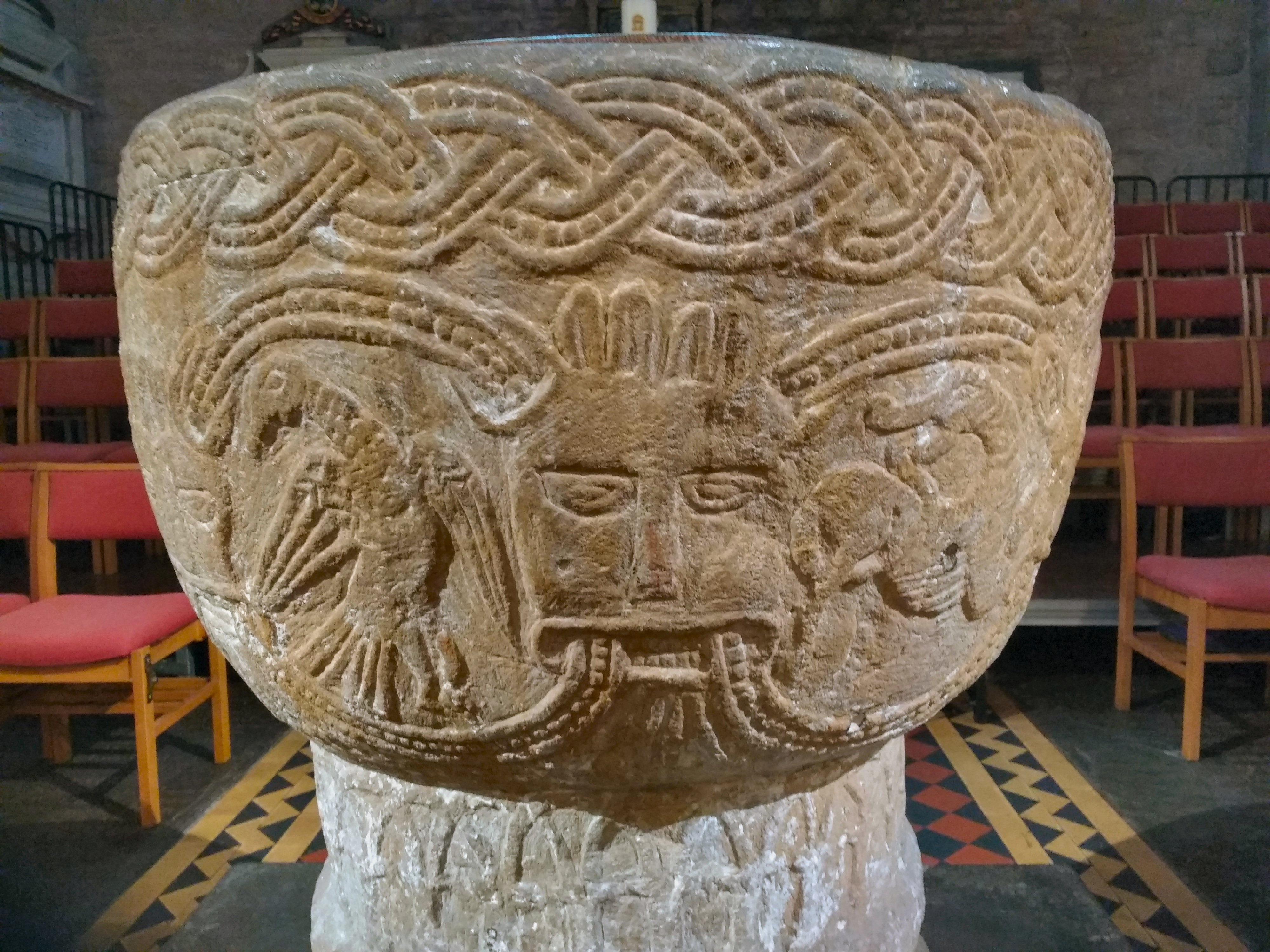 Brecon Cathedral Font with a bird, Green Man and scorpion?
