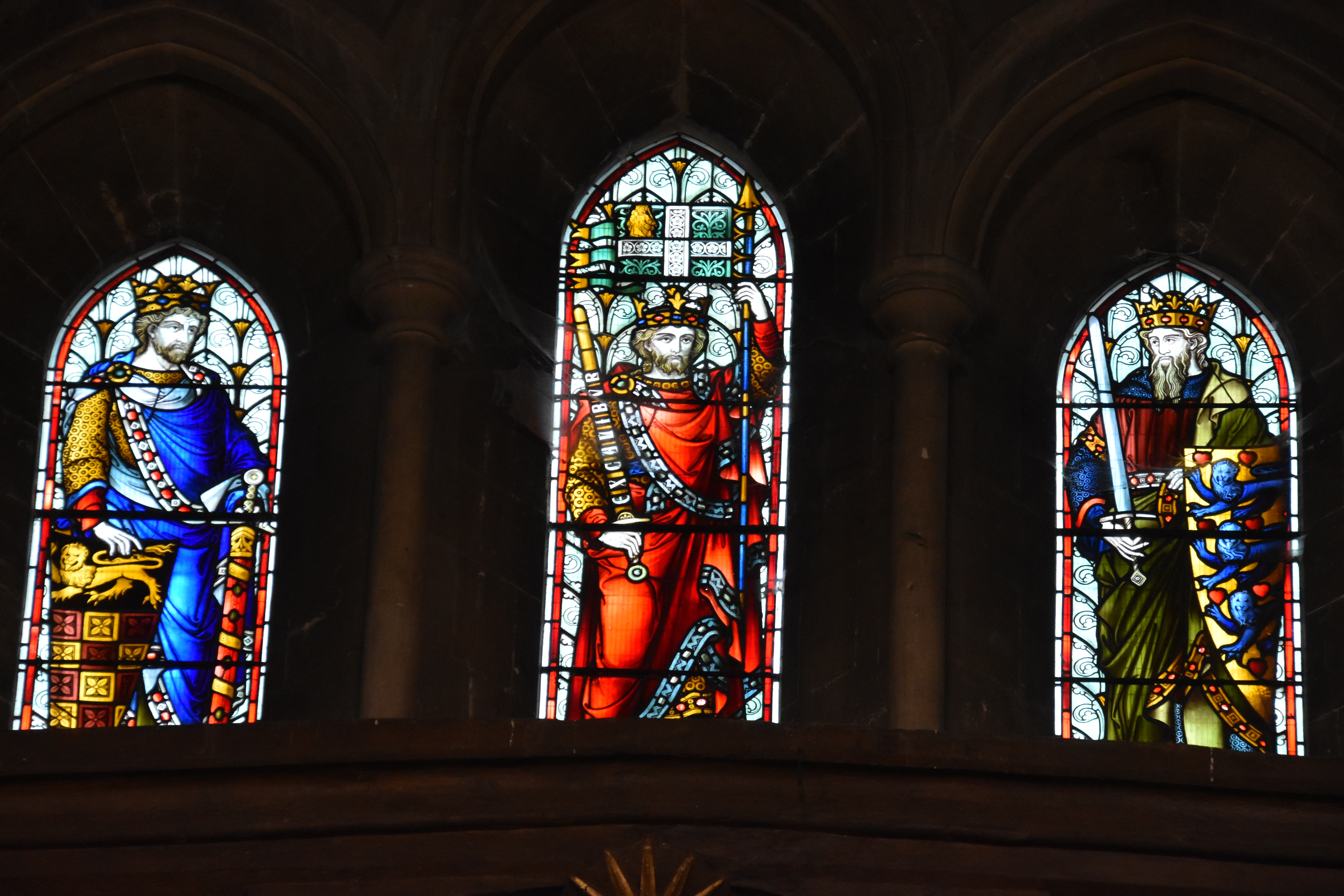 A detail of the stained glass window on the west wall of the Great Hall, Winchester Castle. The central figure is assumed to be King Arthur holding his sword Excalibur.