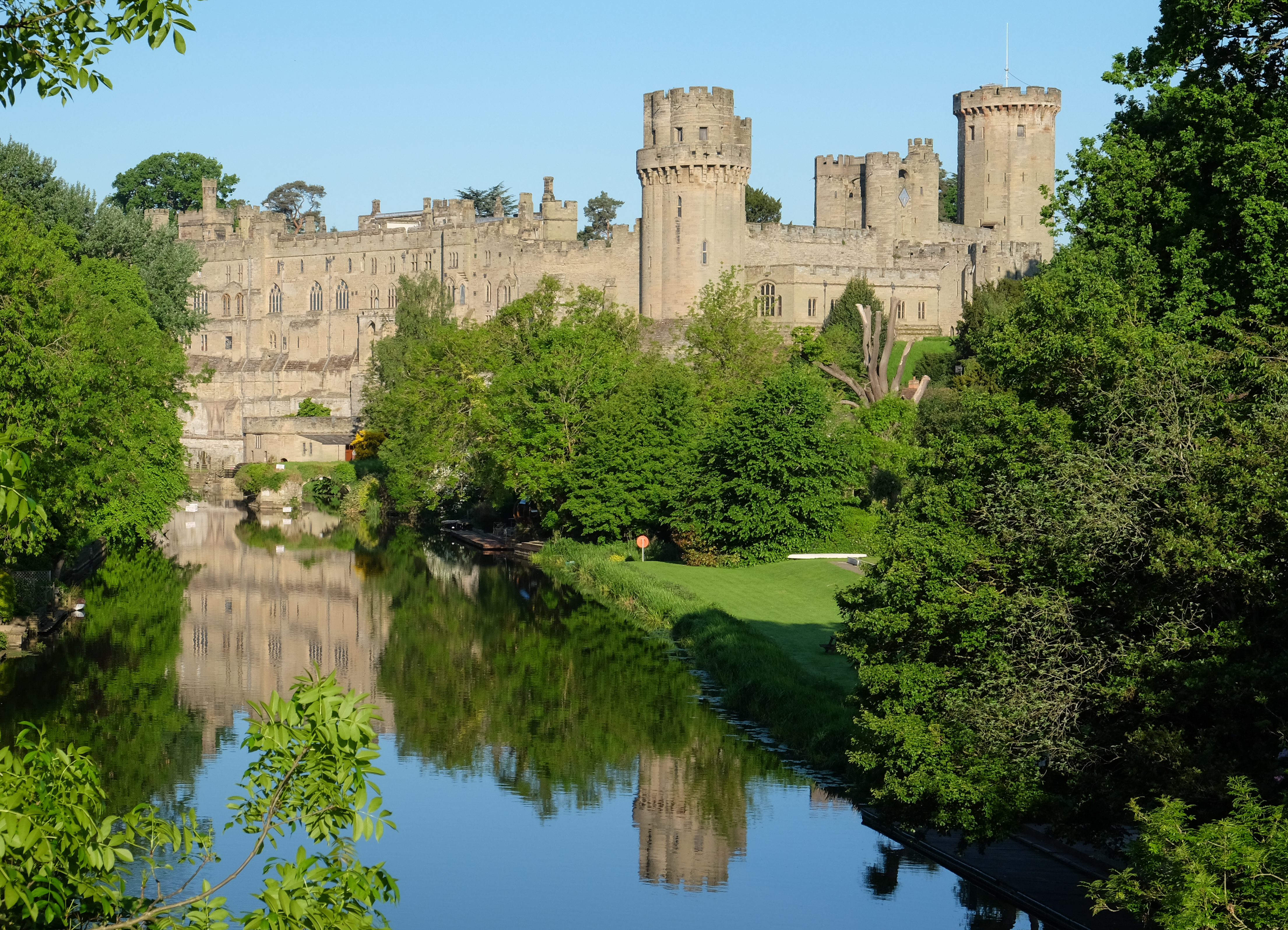 Warwick Castle from the bridge over the River Avon, Warwick, Warwickshire, UK.