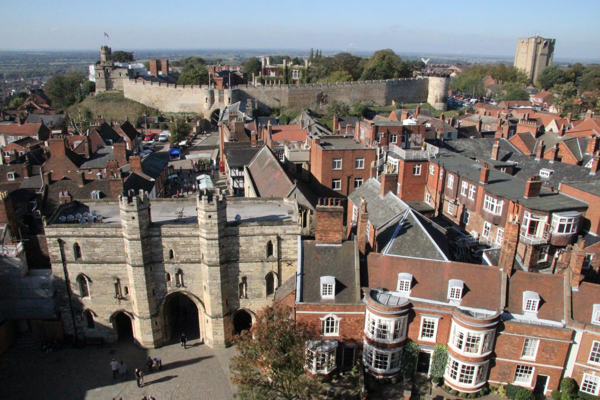 The view west from Lincoln Cathedral. The camera is pointing at the medieval castle. On the left hand side of the castle the 'Lucy Tower' on top of one of the castle's two keeps can be seen. To the right of that the the east gatehouse, and two towers can be seen further to the right.