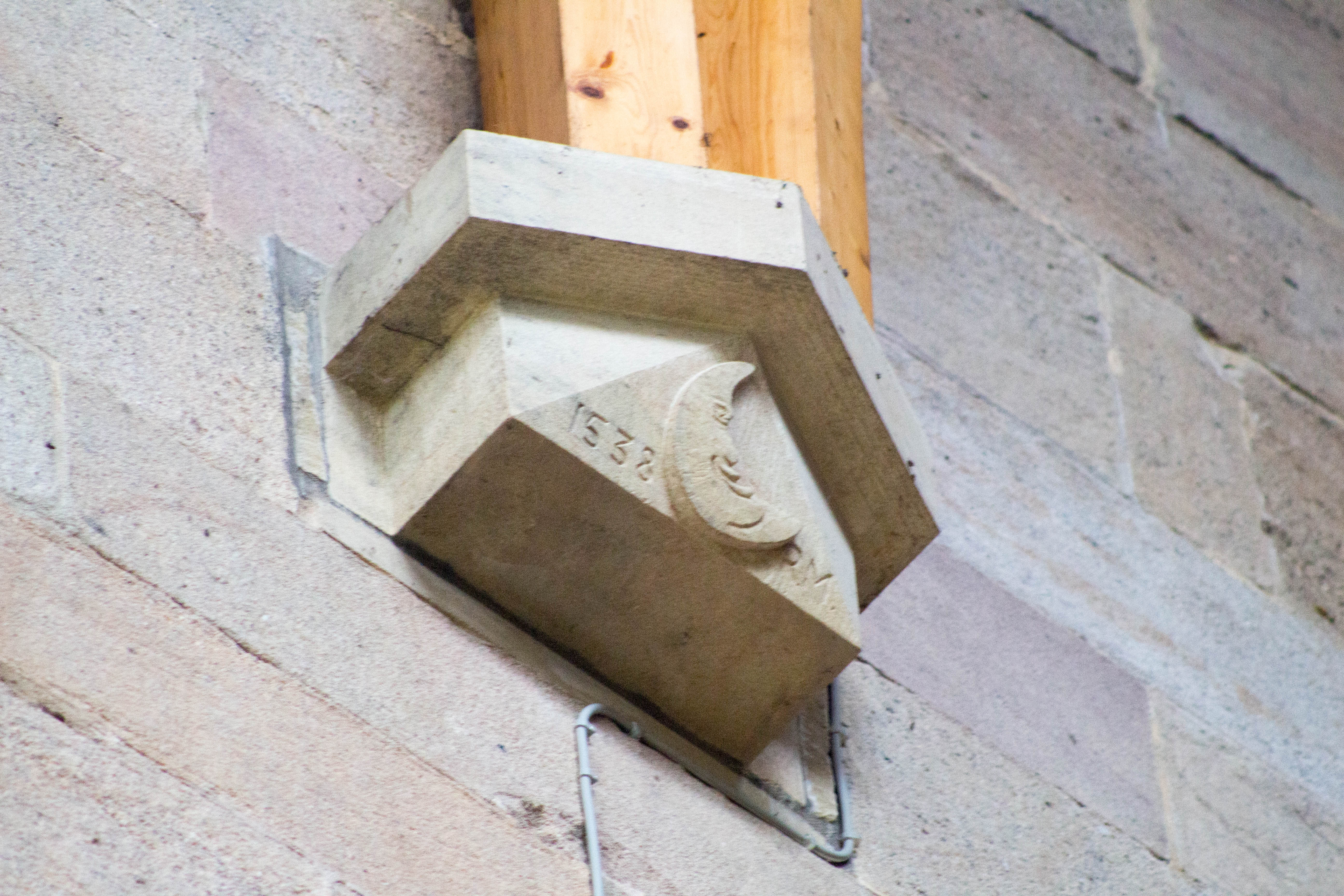 Corbel bearing effigy dedicated to Prior Moone, last prior of the priory before dissolution in the sixteenth century.  Situated in the west tower of the Priory Church of St Mary &amp; St Cuthbert, Bolton Abbey
