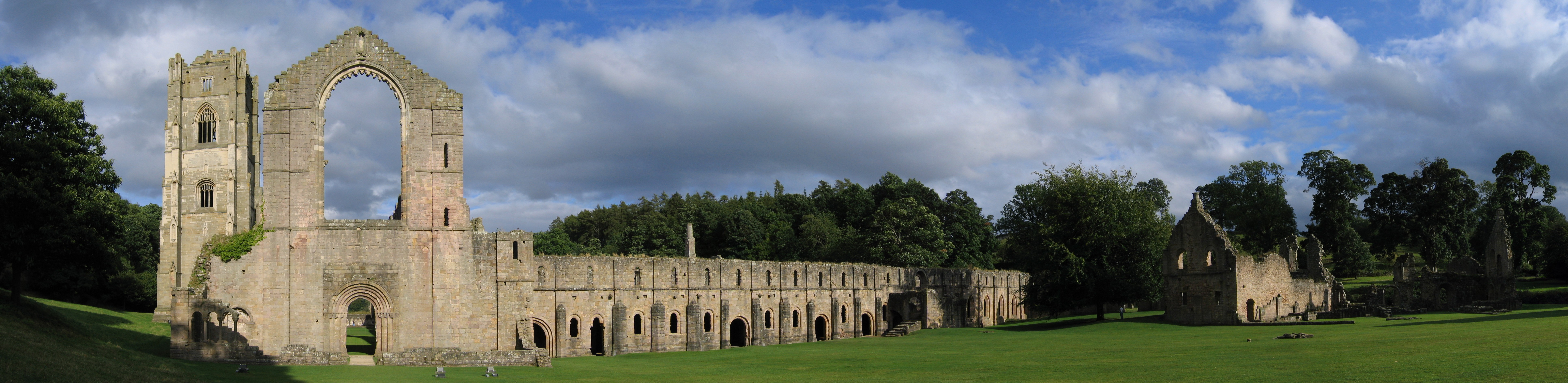 Fountains Abbey ruins seen from West, looking East and South. This abbey in North Yorkshire, England, is a ruined Cistercian monastery, founded in 1132 and operating until 1539.Panoramic image, stitched from own digital photos taken 2005-08-27.The original photo Image:Fountains Abbey view 2005-08-27.jpg extended further right, this has been cropped.