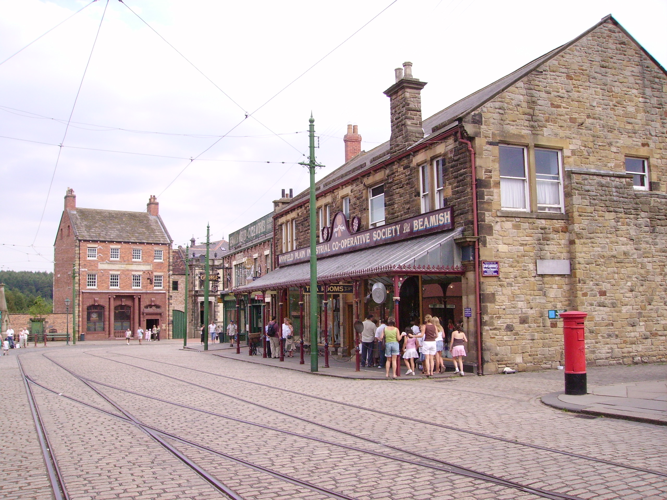 Beamish Museum, County Durham, England. This is the east end of the main street in Town, showing the bank at the end of the street, and the motor showroom/garage &amp; Co-Op general store on the south side.