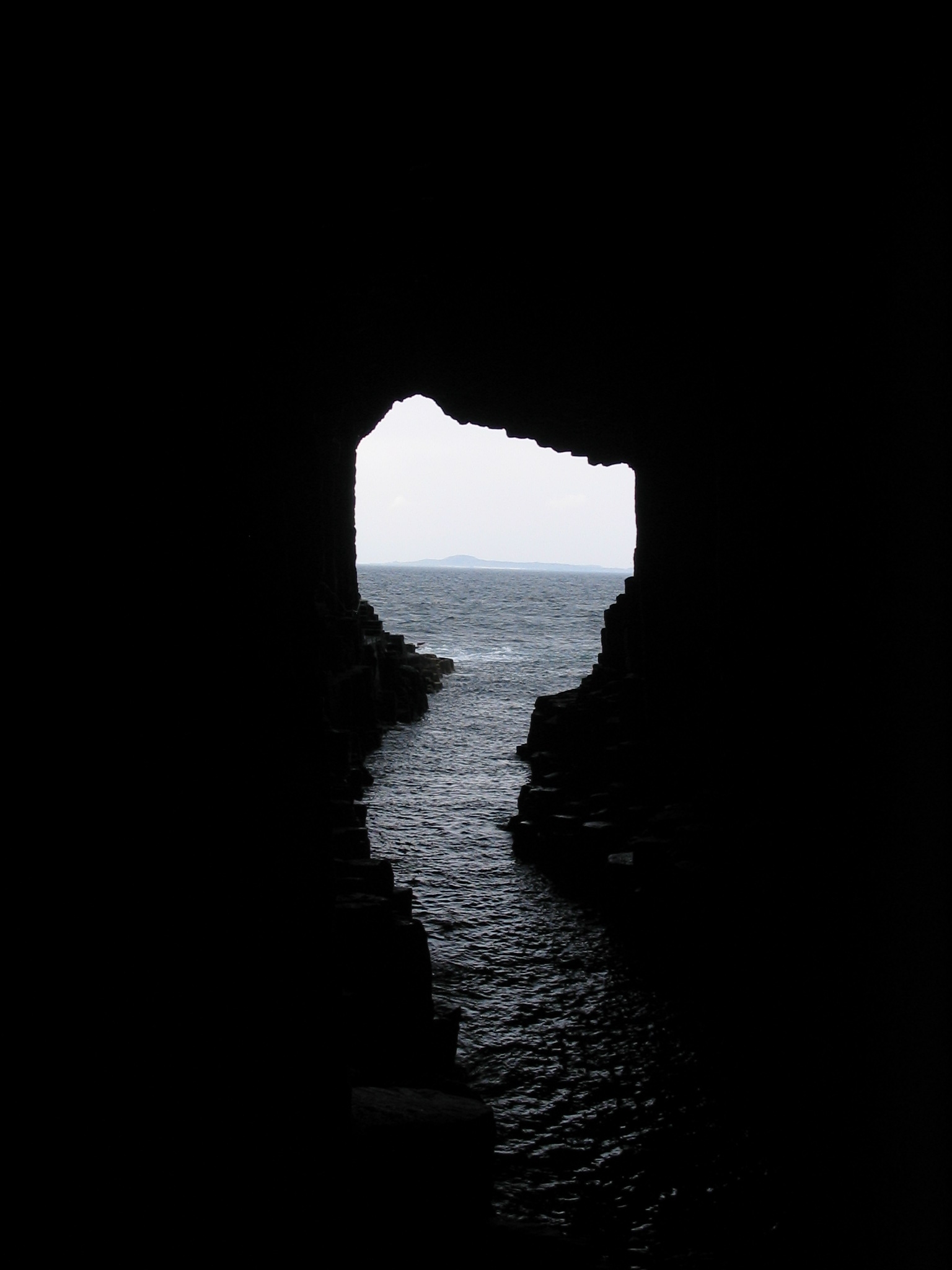 Internal view of Fingal's Cave on the island of Staffa, with a view across the open sea to the island of Iona, both are islands of the Inner Hebrides in Argyll and Bute, Scotland.  Photo taken May 2008.