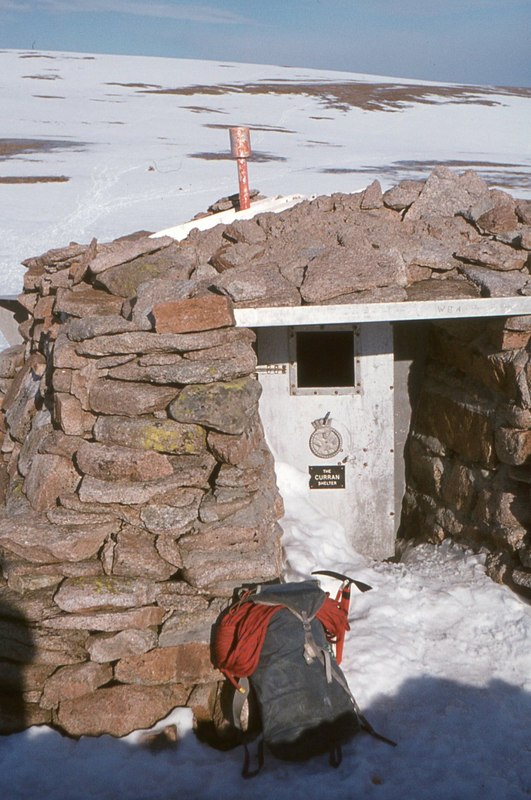 Curran Bothy, Cairngorm Plateau This small stone-built shelter was the overnight destination for two school groups on a mountaineering expedition on 19th November 1971. One group arrived in deteriorating weather, but the others could not find it in bad visibility and blowing snow. They bivouaced but after a second night out, only two survivors were found by rescue teams. The remaining five schoolchildren and an 18-year-old student teacher died.
A few years later, this and some other high-level shelters were removed.

On this visit in 1975, the shelter was part filled with snow which had either come through the doorway or chinks in the walls. In heavy snow years, the whole structure could be buried, with only the chimney protruding from the surface.