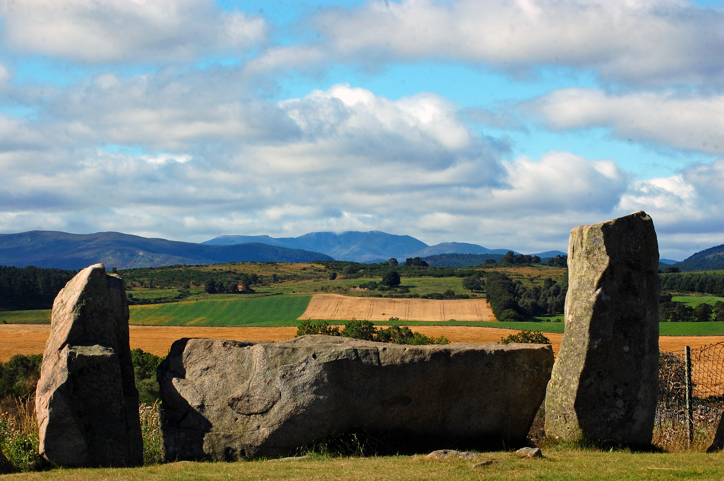 The approx. 4,000 year-old ring of stones near the village of Tarland in Aberdeenshire is one of almost 100 recumbent stone circles found in the north-east of Scotland.
The two upright stones flanking a large recumbent stone shown here frame the hills of Lochnagar( in the distance) and may have been used by early farmers for lunar observation.