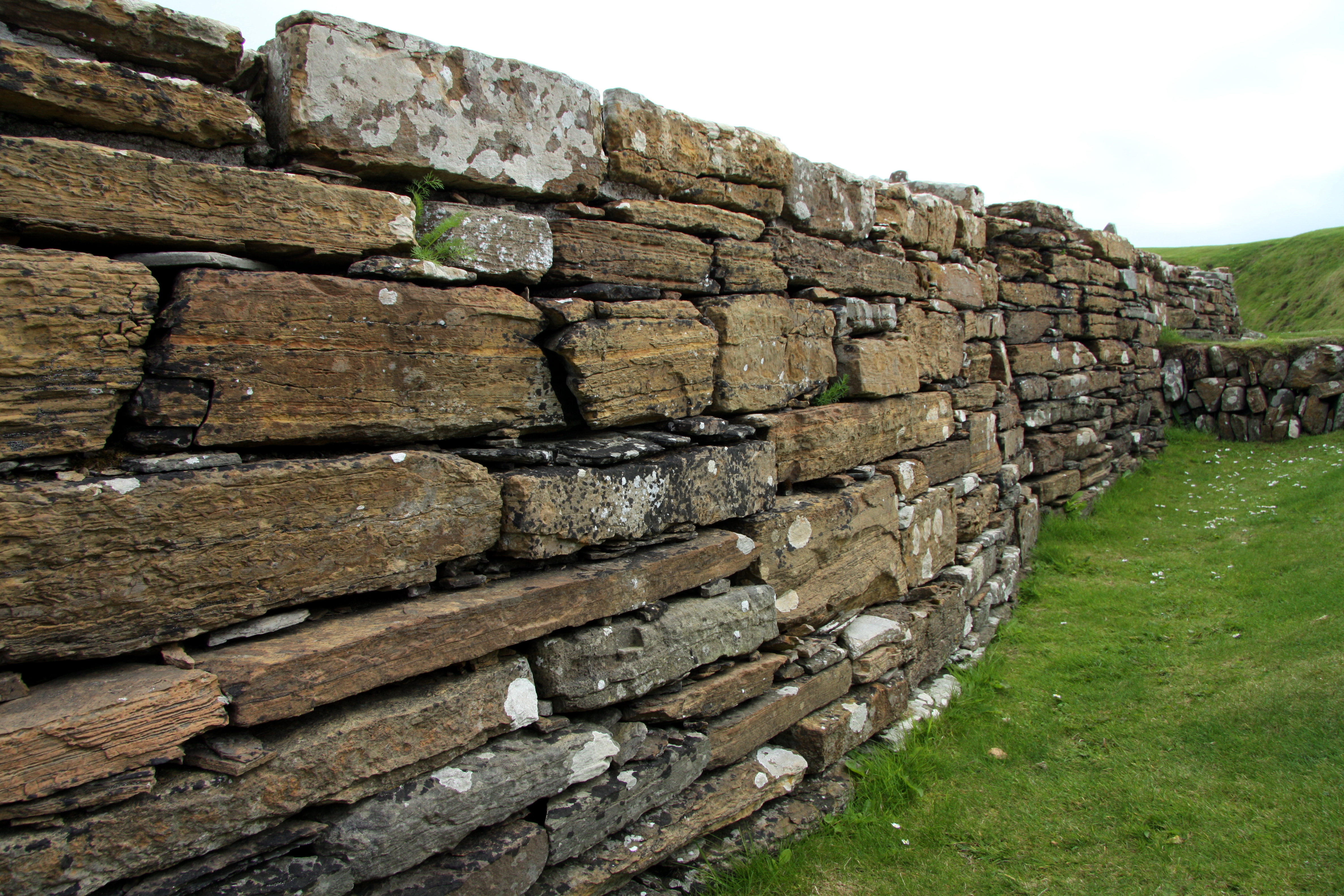 he Broch of Gurness is an Iron Age broch village on the northwest coast of Mainland Orkney in Scotland overlooking Eynhallow Sound.