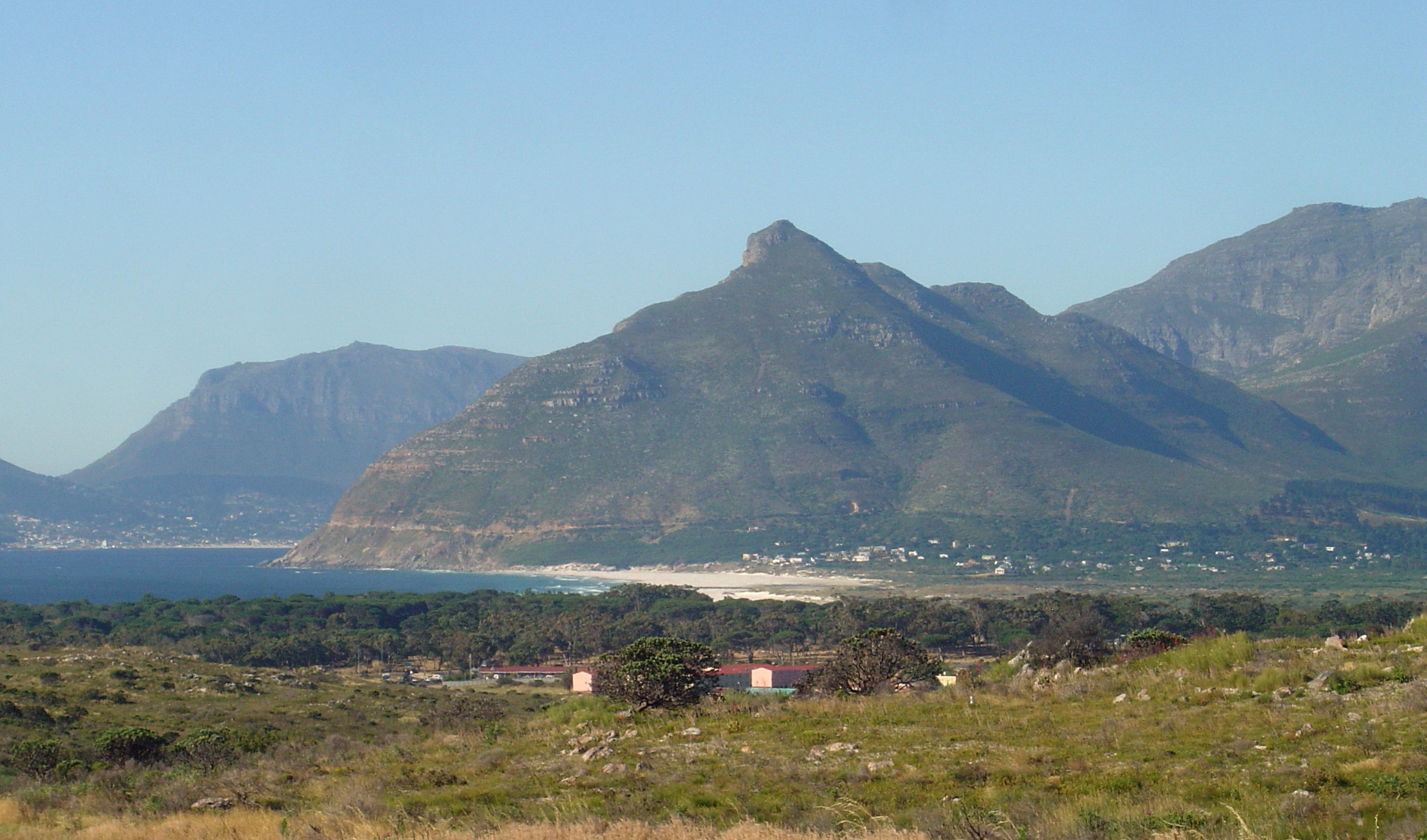 Chapman's Peak in Cape Town, seen from Kommetjie. Hout Bay is on the left, and Constantiaberg on the right.
