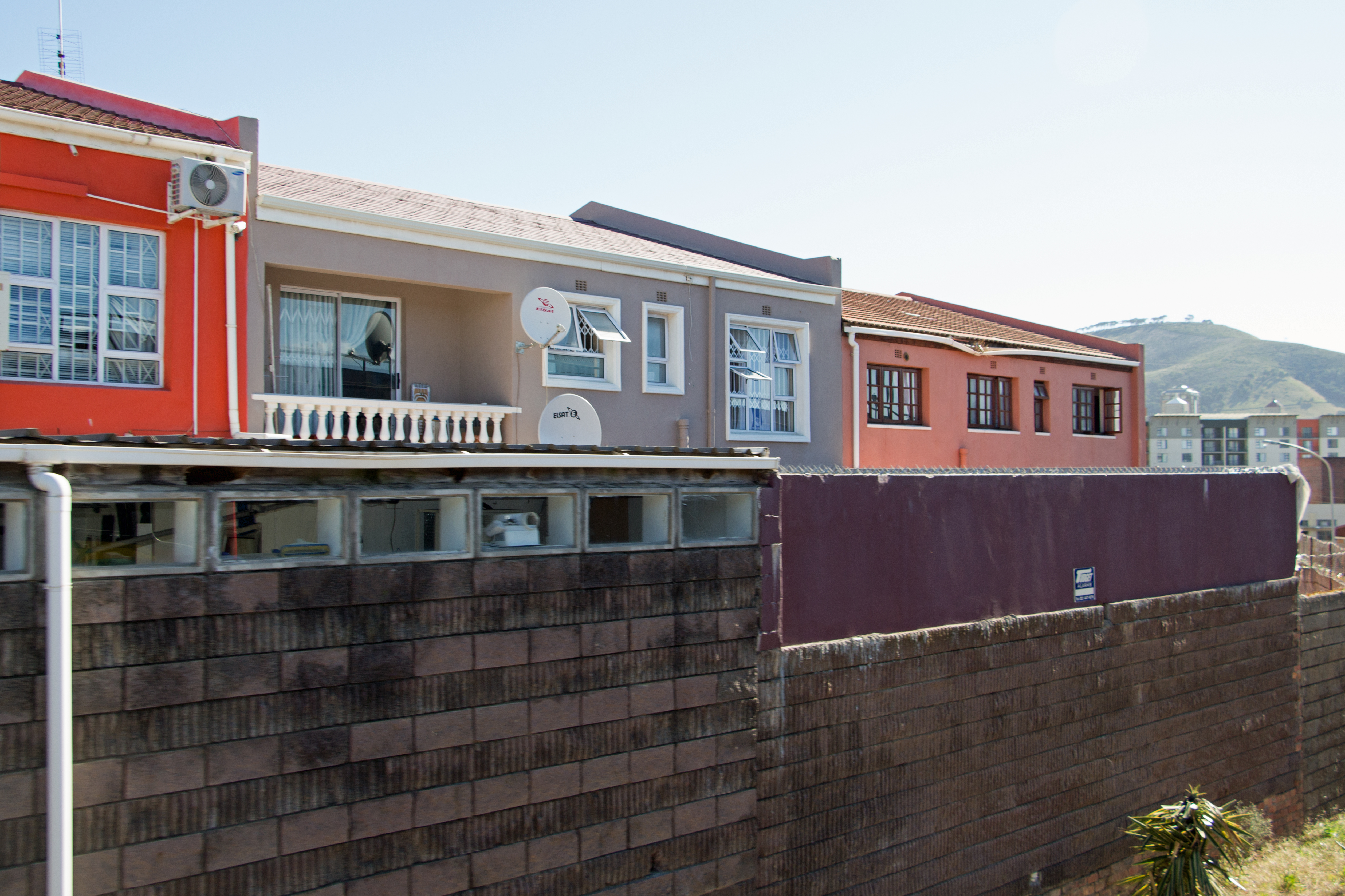 Colourful houses in District Six, Cape Town, South Africa. Signal Hill is visible in the background.