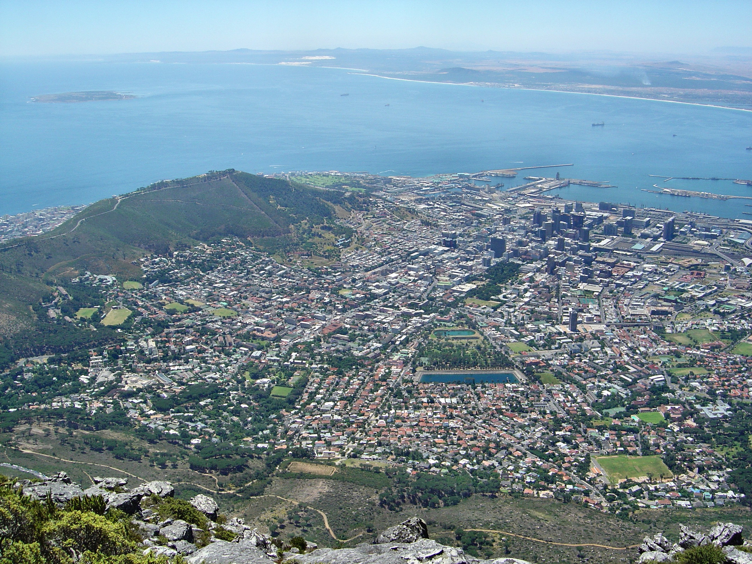 The central area of Cape Town and the Waterfront Harbour as seen from Table Mountain. The Island on the left is Robben Island where Nelson Mandela was kept imprisoned for so many years.