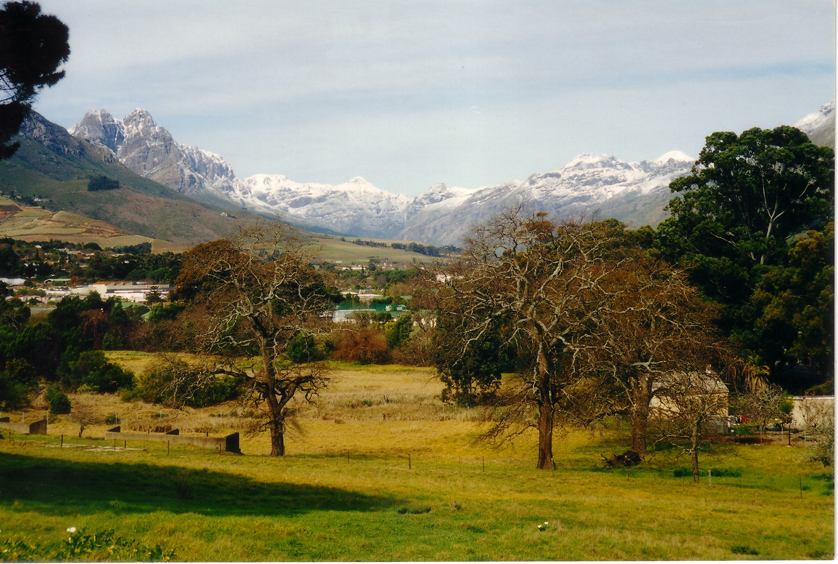 Jonkershoek Valley and the Groot Drakenstein Mountains, seen from Stellenbosch, Western Cape. Victoria Peak (1,590 m (5,220 ft)) is the portion covered in heaviest snow the middle background.