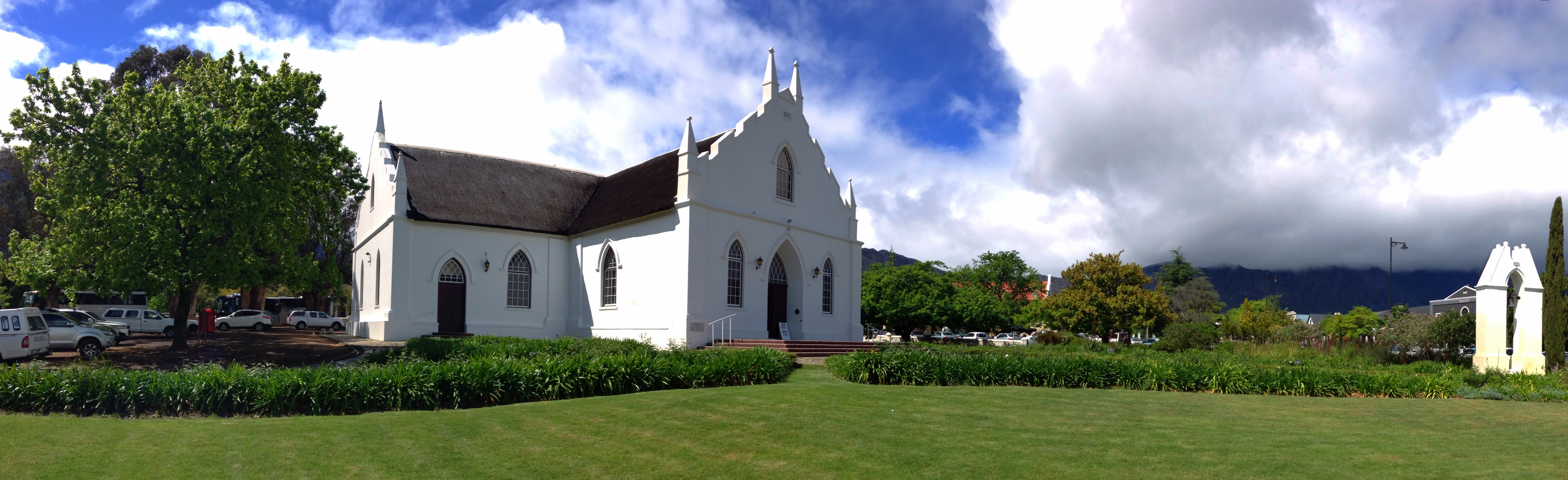 A panoramic view of the Dutch Reformed Church in Franschhoek. The church bell is visible on the far right of the picture.