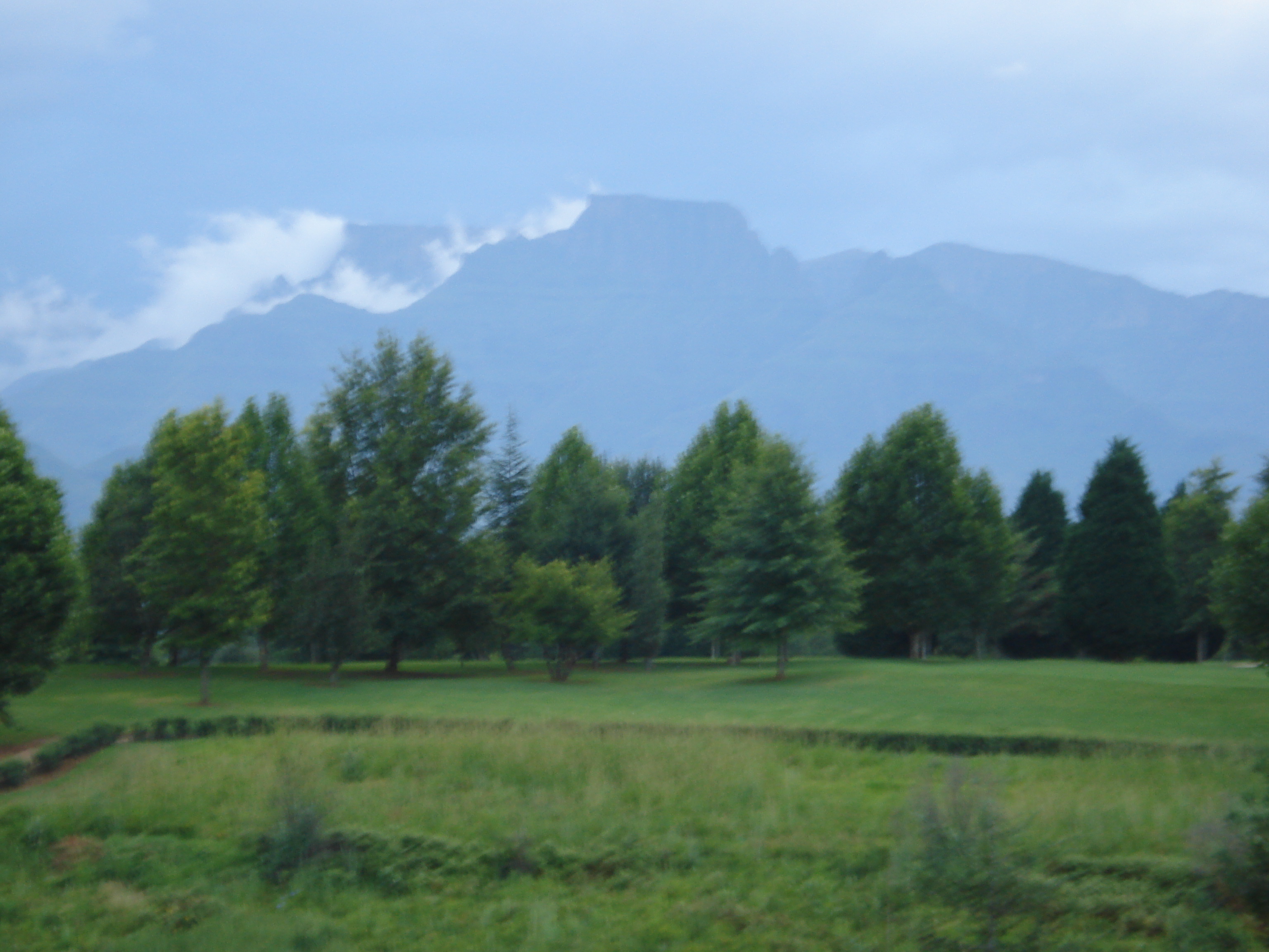 Cathkin Peak, 3182m above sea level in the foreground, and Champagne Castle, 3377m a.s.l., surrounded by clouds in the background, KwaZulu-Natal Drakensberg, South Africa