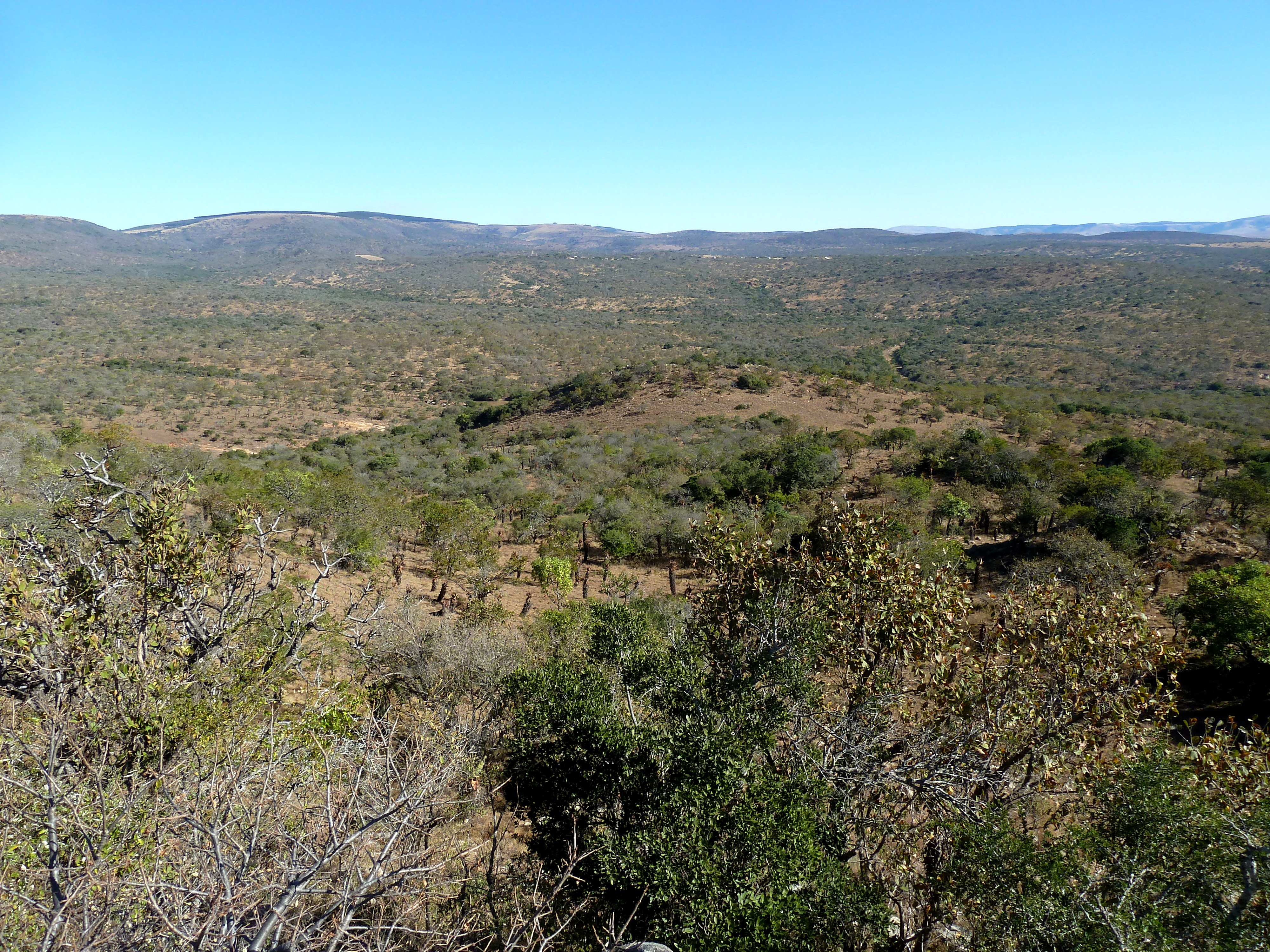 Looking east over the eMakhosini valley, as seen from the eMakhosini Monument on Khumba hill, eMakhosini, northern KwaZulu-Natal. uMgungundlovu and the nearby NGK mission, 4 km distant, are barely visible at center as an open area on a hilltop, above the rounded hill in the foreground.
